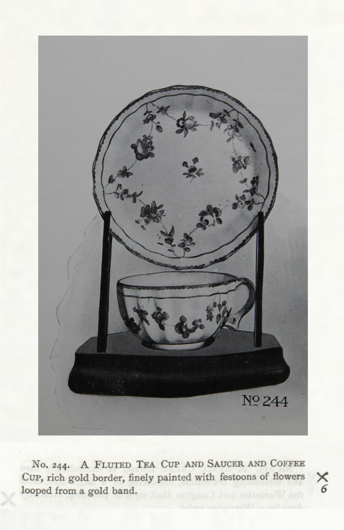 A teacup and saucer with garland suspended from gilt line, No. 244 in the Trapnell Collection