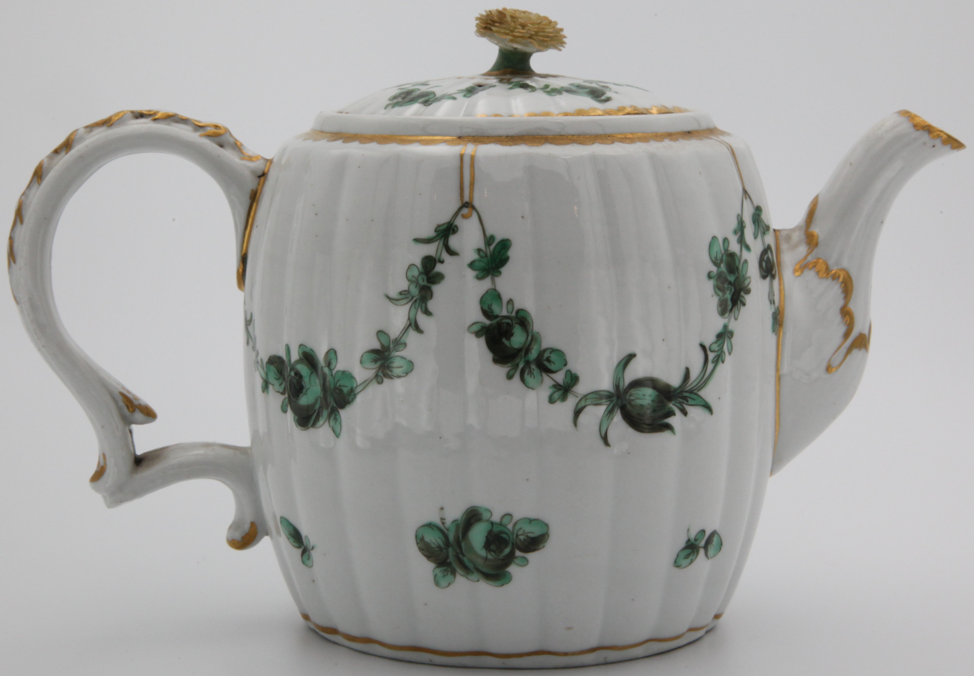 A fine Bristol fluted barrel-shaped teapot and cover from the Horace Walpole service, with finely modelled flower knop and harebell-moulded and gilt painted handle, painted in monochrome green with garlands of leaves and flowers suspended from gilt loops, gilt dentil borders, blue X and 1 marks.