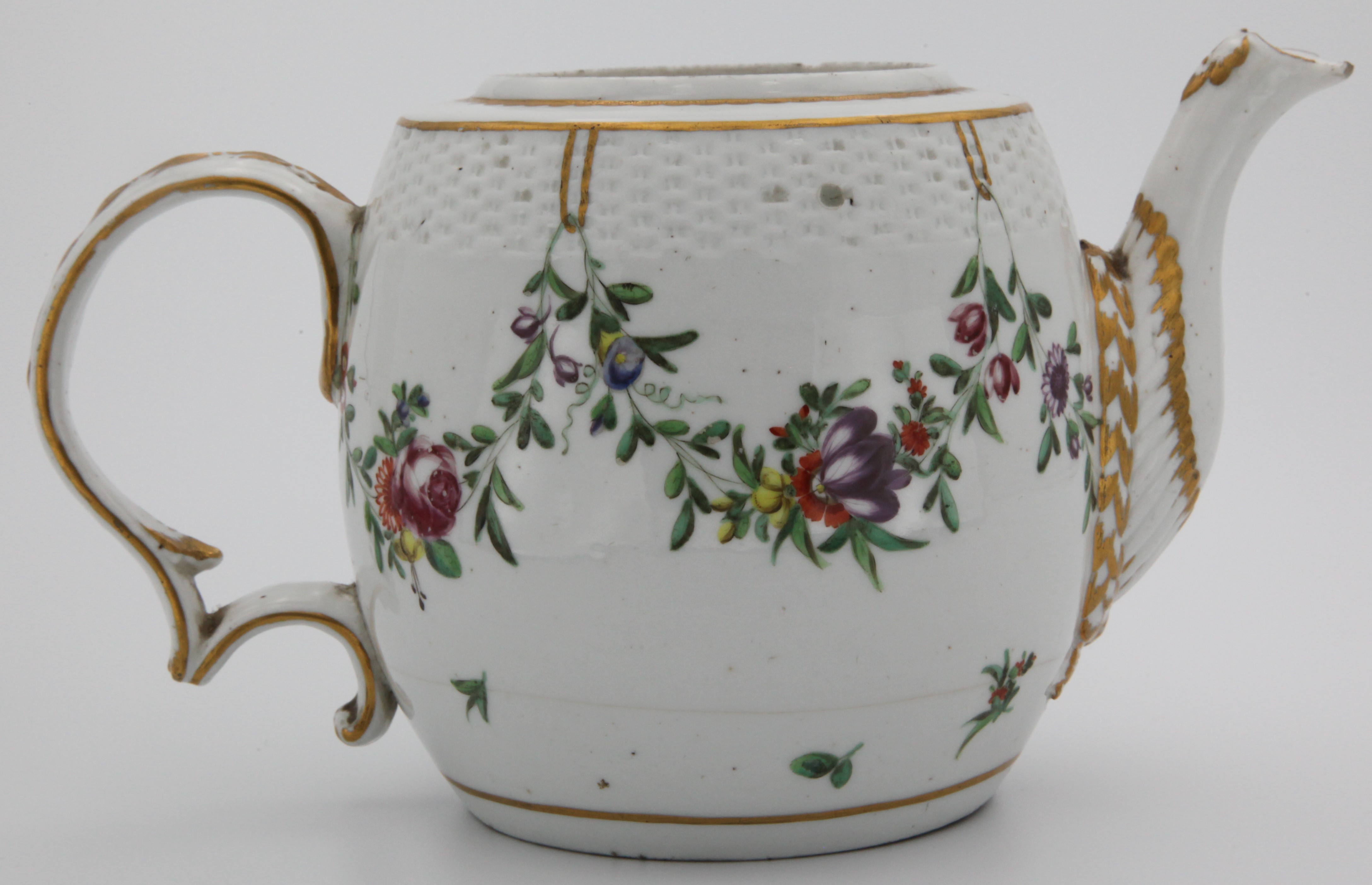 A Bristol barrel-shaped teapot, lacking cover, with harebell-moulded scroll handle, a basket-moulded band to the upper body, painted in coloured enamels with garlands of flowers and leaves, suspended from gilt loops within gilt dentil borders. c1777. Blue X and 3 marks