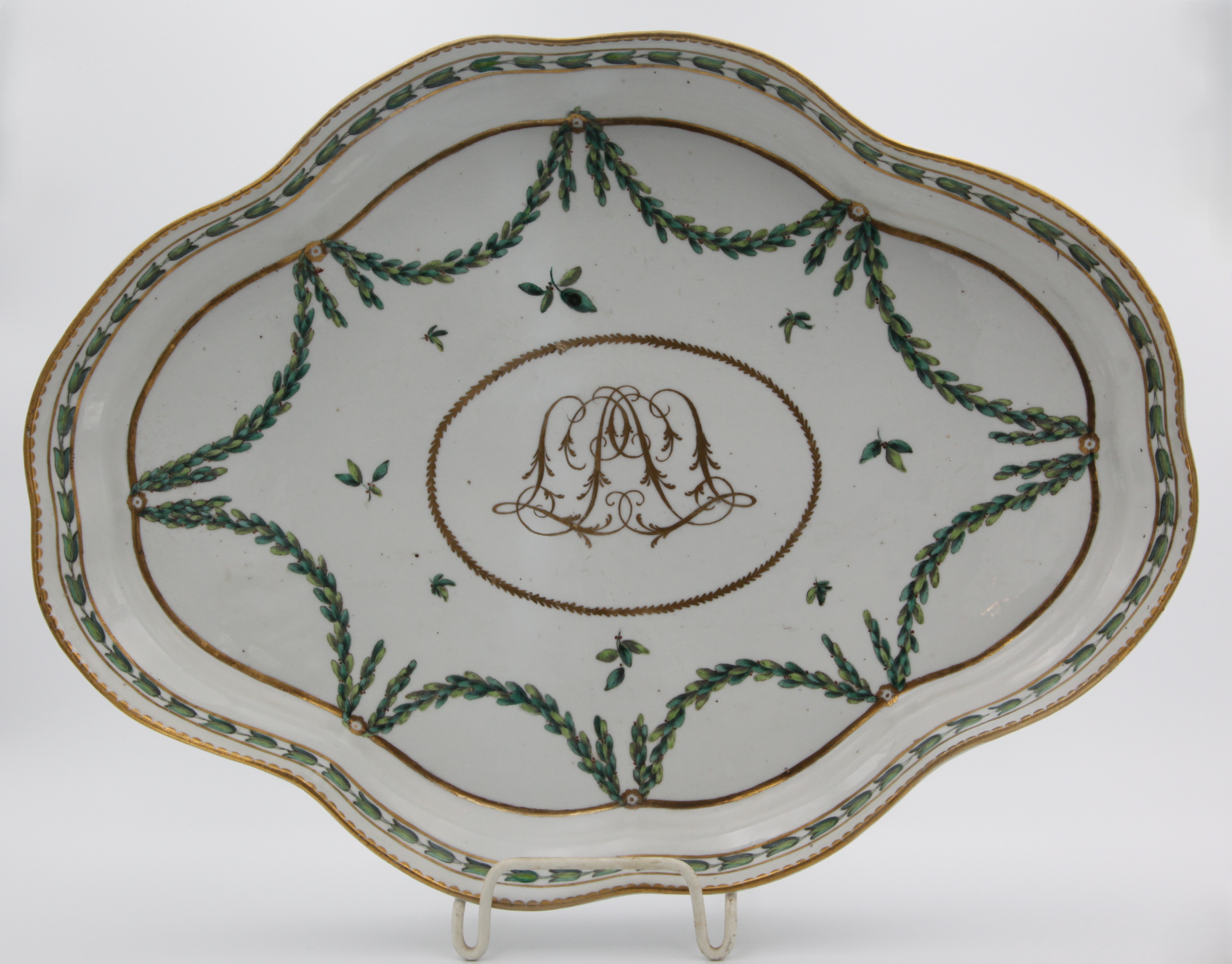 A large Bristol ogee-shaped lobed tray, with ornate central gilt monogram (JAC?) surrounded by gilt band, painted in enamels with laurel garlands suspended from gilt roundels on a thick gilt band, a band of harebells between two gilt lines on the raised sides and gilt dentil rim, the mark a grand cursive B in light grey with numeral 3 in pale blue