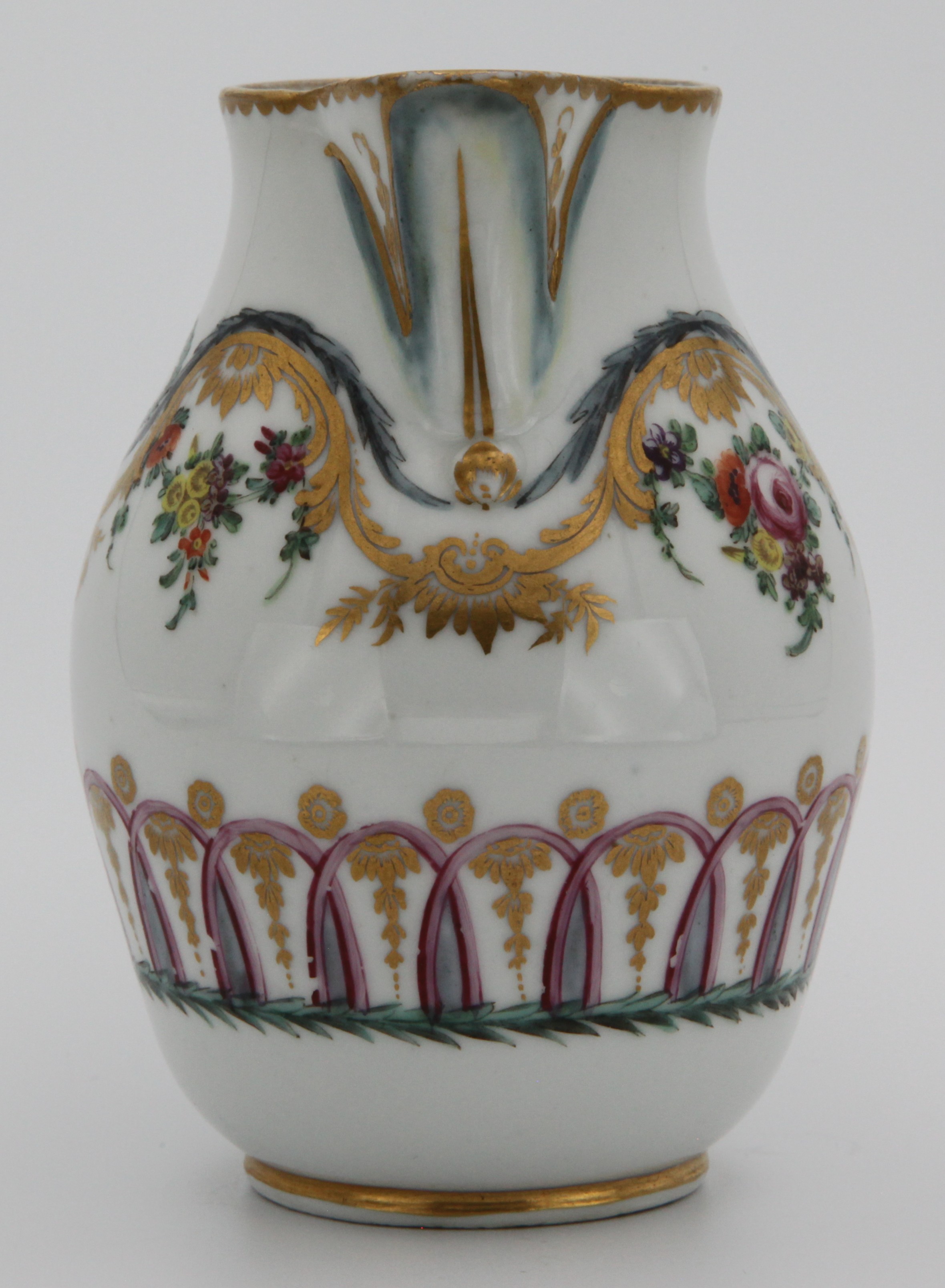 A Bristol ovoid milk jug, with crabstock loop handle and leaf moulded lip, painted in coloured enamels with festoons of flowers and leaves, suspended from gilt 'C' and leaf scrolls, stiff blue leaves and laurel garlands, above a puce, blue and gilt interlinked band, gilt dentil rim, circa 1772, elegant numeral 2 mark in gilt.