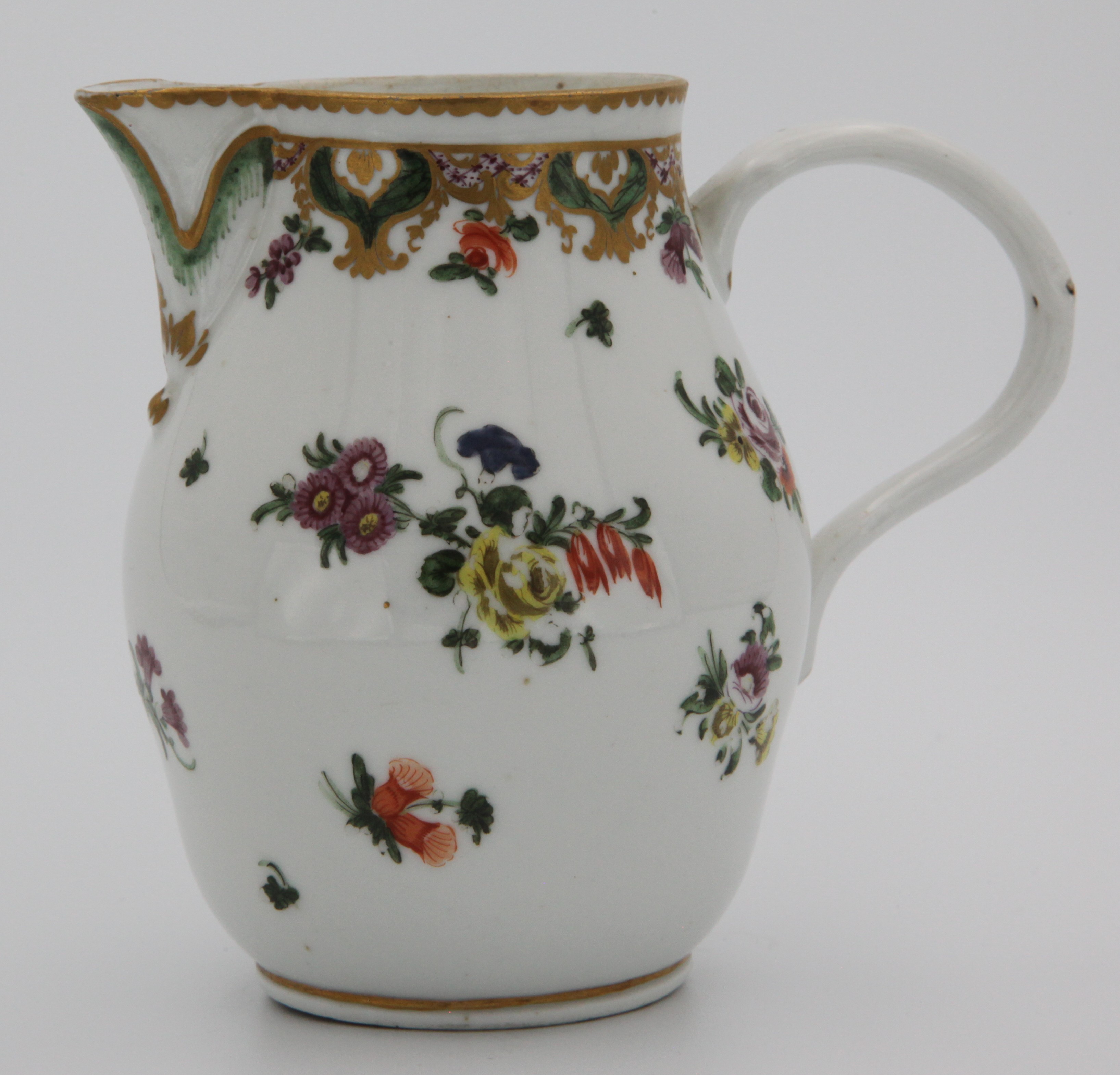 A Bristol ovoid milk jug, with crabstock loop handle and leaf moulded lip, painted in coloured enamels in Ludlow service style with scattered flower sprays, beneath a puce scale band, with green and gilt cartouches of flowers and leaves, and pendant flowers, circa 1775, no mark