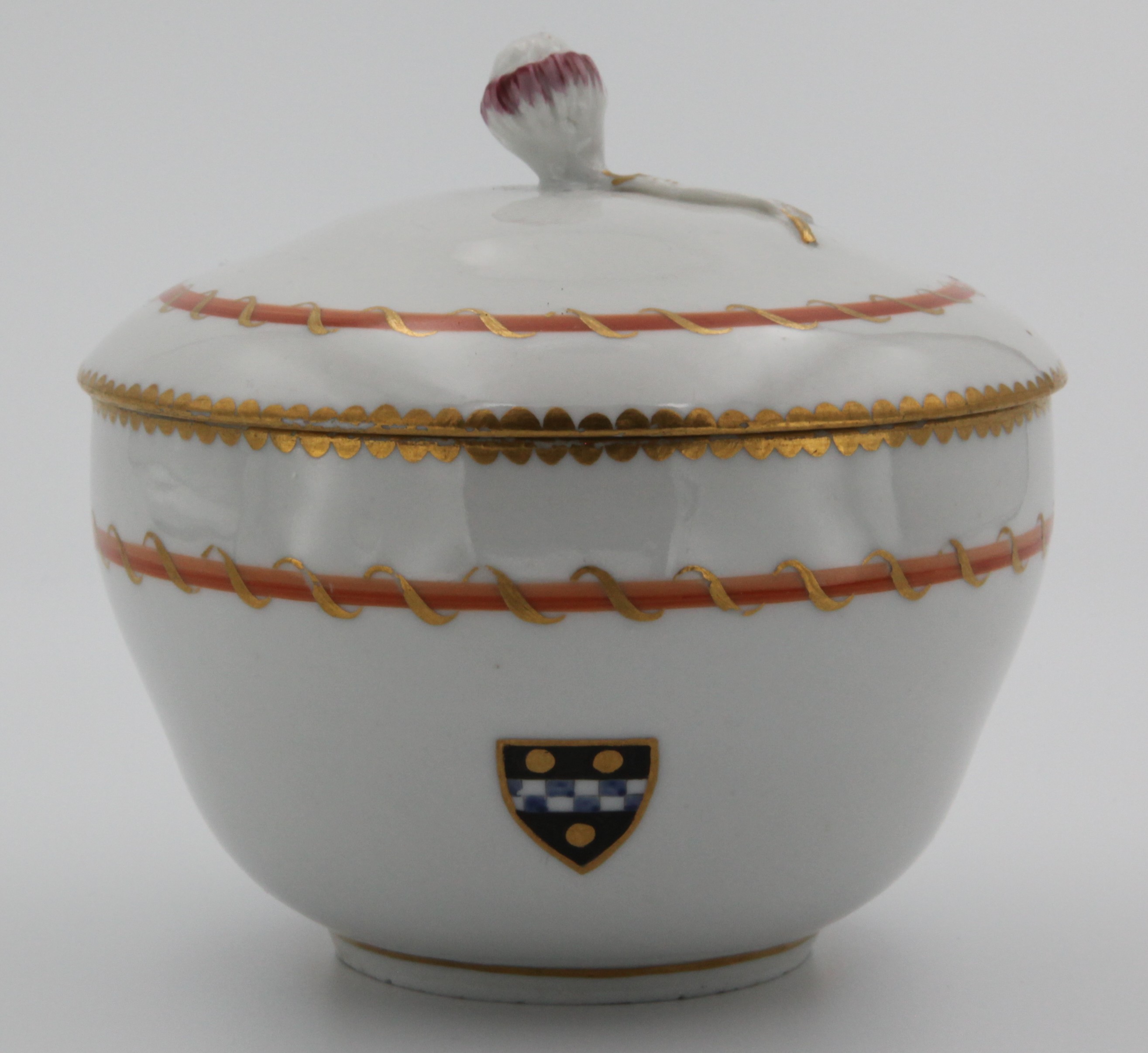 A Bristol ogee-shaped sucrier and cover, with flower bud and leaf knop, from the Pitt Service, painted with the Pitt armorial, within a shield shaped cartouche, and orange and gilt entwined bands, gilt dentil rims, circa 1775, no mark.