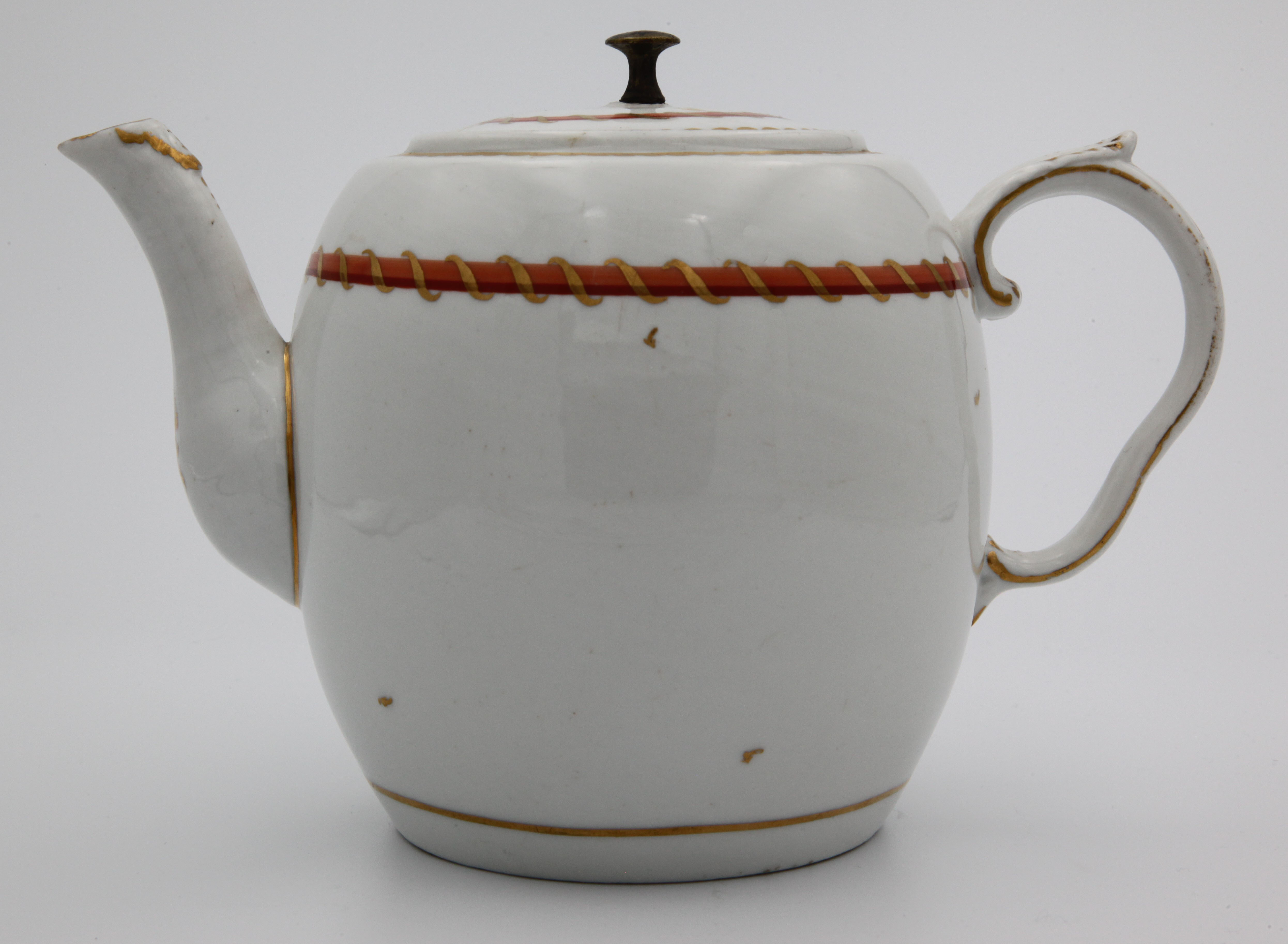 A Bristol barrel-shaped teapot and cover, the cover with replacement iron knop, the pot with moulded ear-shaped handle decorated with gilt harebells, gilt decoration to moulded spout, painted in enamel with orange, red and gilt entwined bands (the pattern of the Pitt service) with gilt dentil rim and scattered leaves, circa 1775, painted blue X mark
