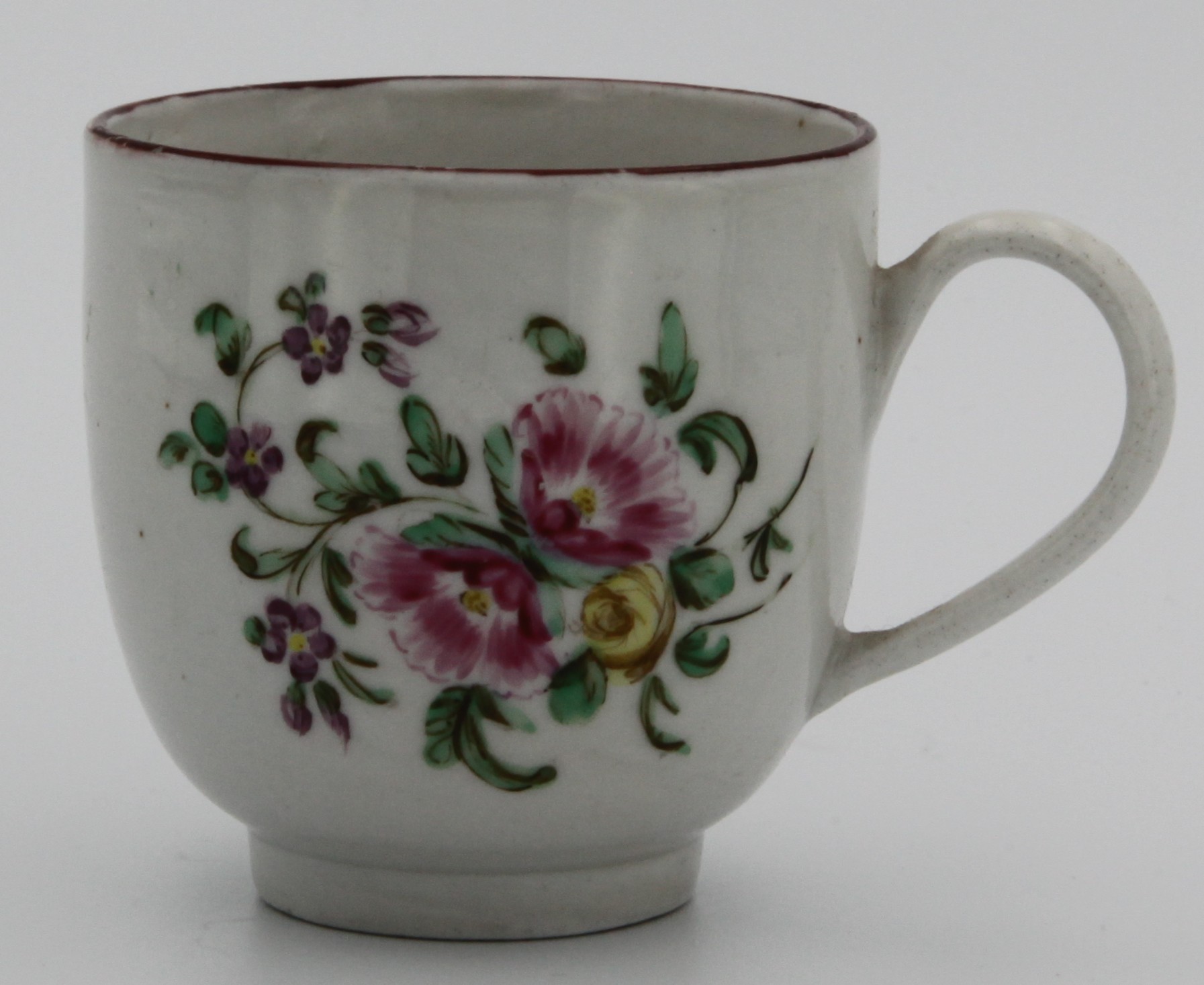A Bristol coffee cup, painted with a bouquet of two pink and one yellow summer flowers, iron red line border, marked with an X.16, c. 1770