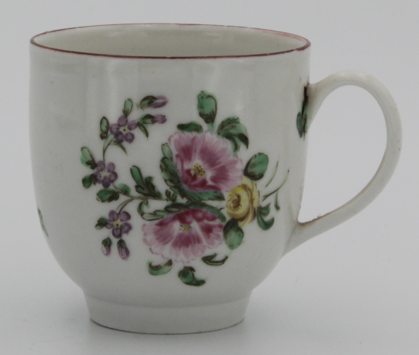 A Bristol coffee cup, painted with a bouquet of two pink and one yellow summer flowers, iron red line border, marked with an X 16, c. 1770