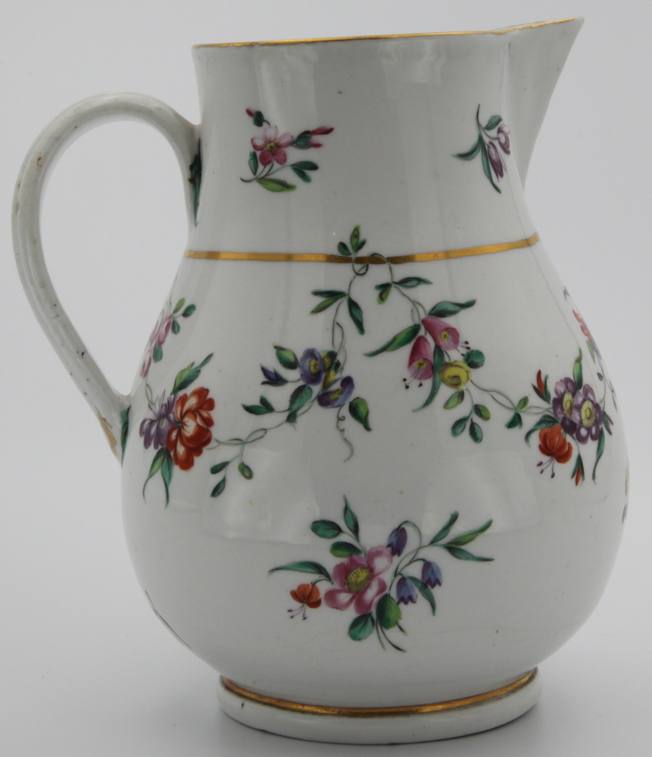 A Bristol porcelain jug, large baluster form with sparrow beak and ridged handle (wonky), finely painted with a swagged floral vine suspended from a gilt band, between floral sprigs and sprays, blue B mark.