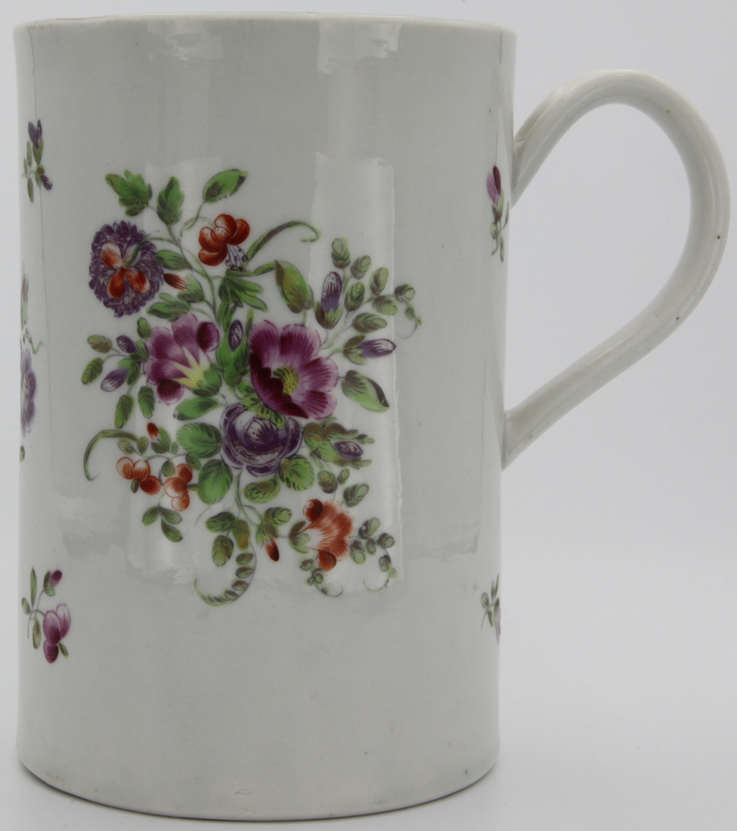 A large Bristol mug with convex plain handle decorated in gilt,  finely painted in enamels with sprays of flowers and leaves, gilt rim. 15.5 cm high. No mark but circle on base.