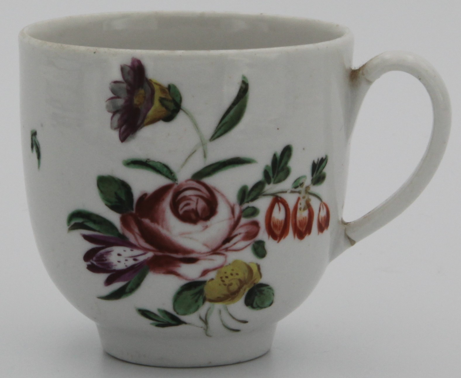 A Bristol porcelain cup: enamelled in colours with a rose centred bouquet and scattered sprays, painted blue cross and numeral 19. circa 1770-80