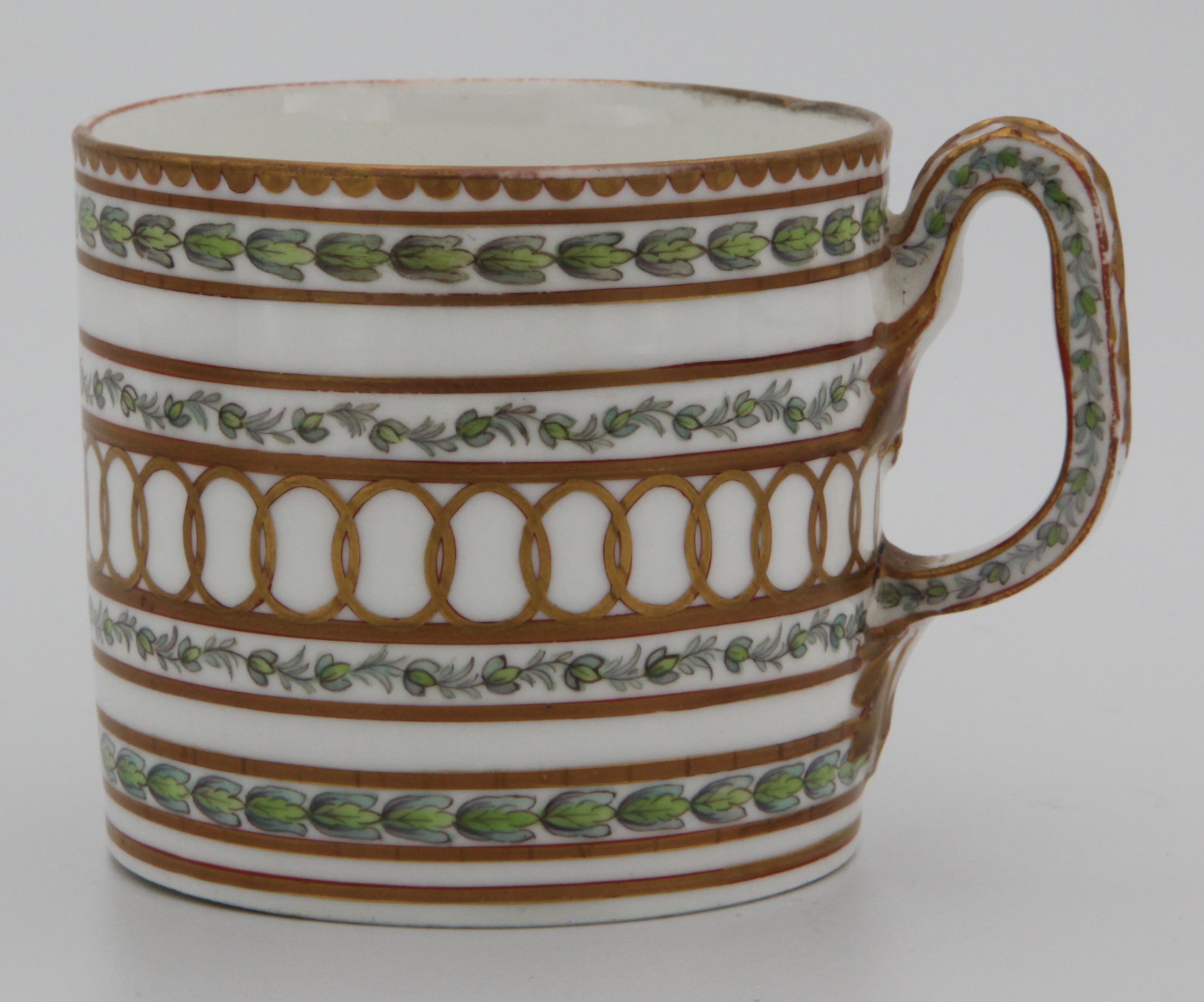 A fine Bristol cabinet cup with bands of gilding and laurel leaves, with faceted loop handle with harebell moulding decorated in gilt, the cup painted in green and puce with bands of leaves, within gilt line and interlinked roundel bands, gilt dentil rims,  Bristol blue X mark and numeral 1 in gilt, c.1775.