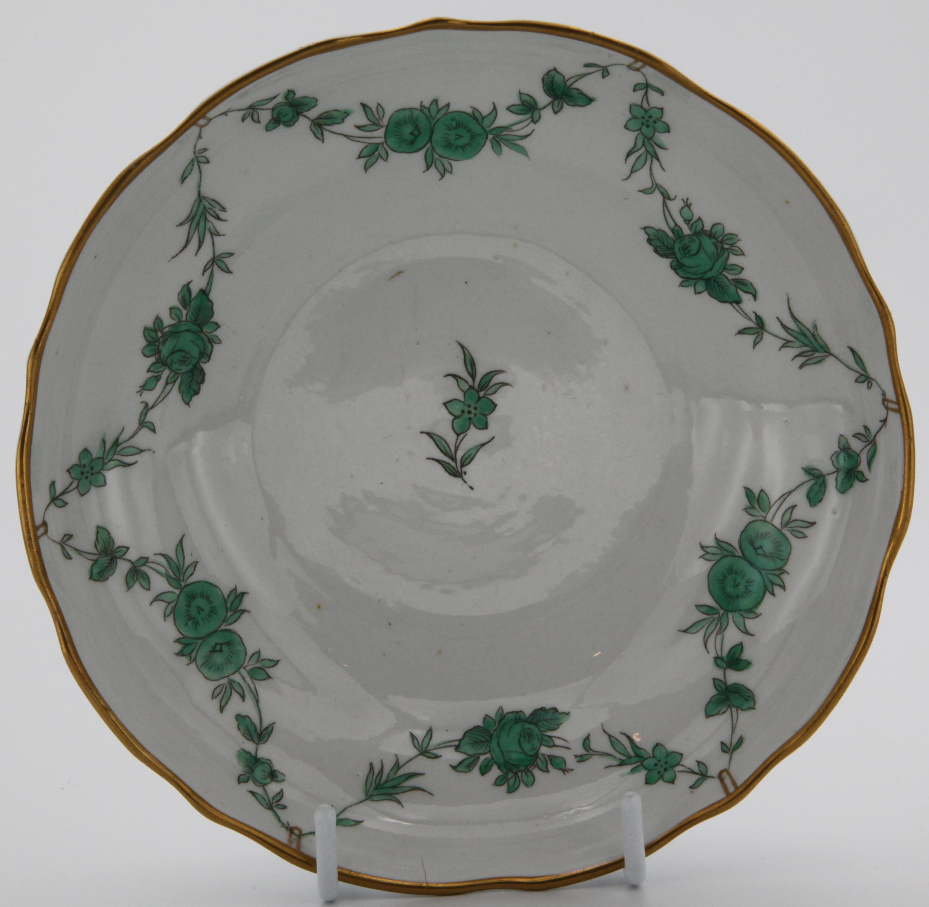 A Bristol William Cookworthy porcelain saucer dish (green swag garlands of leaves and flowers supported from gold rim) 14cm, X10 mark