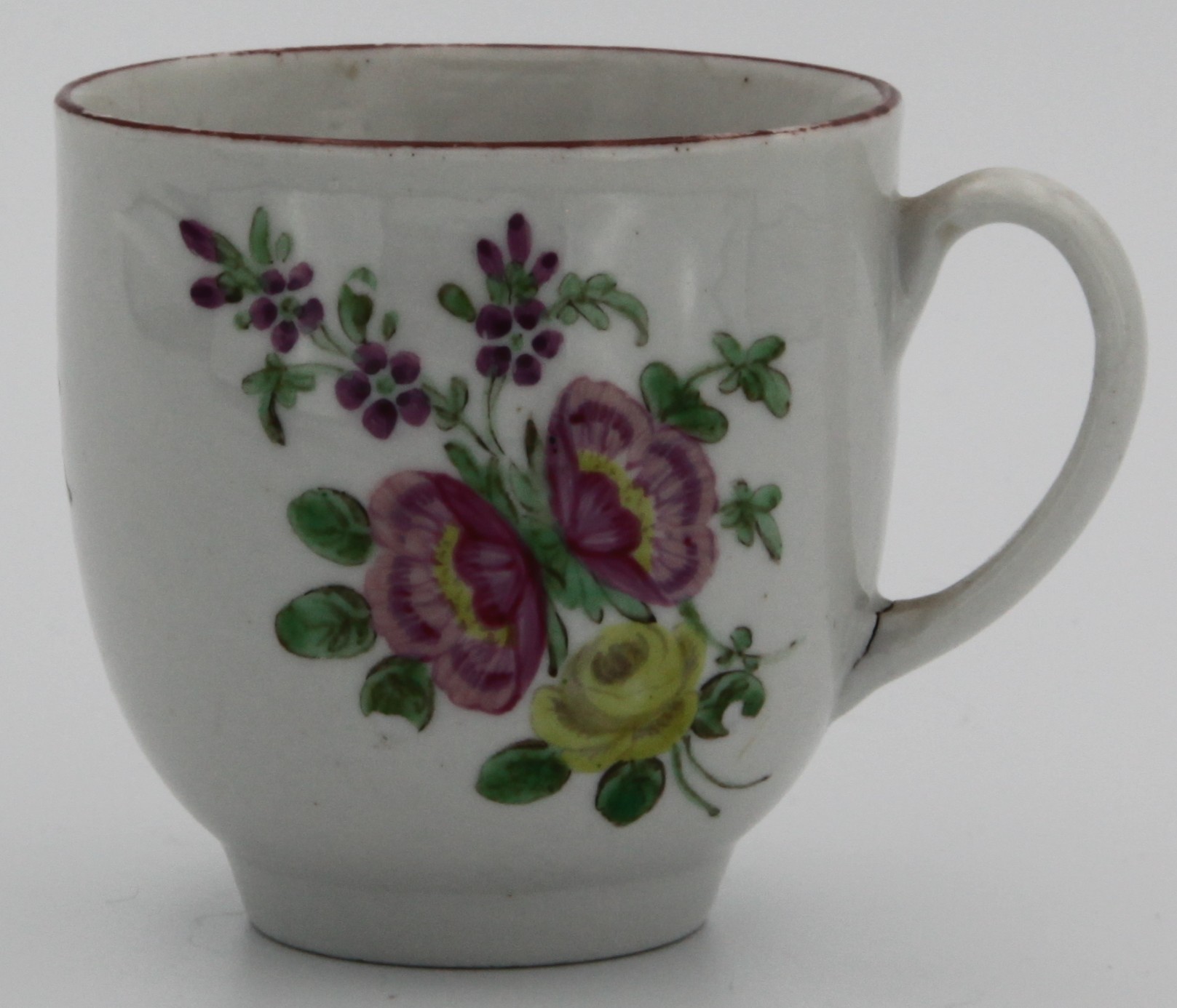 A Bristol coffee cup, painted with a bouquet of two pink and one yellow summer flowers, iron red line border, marked with a painted X7., c. 1770
