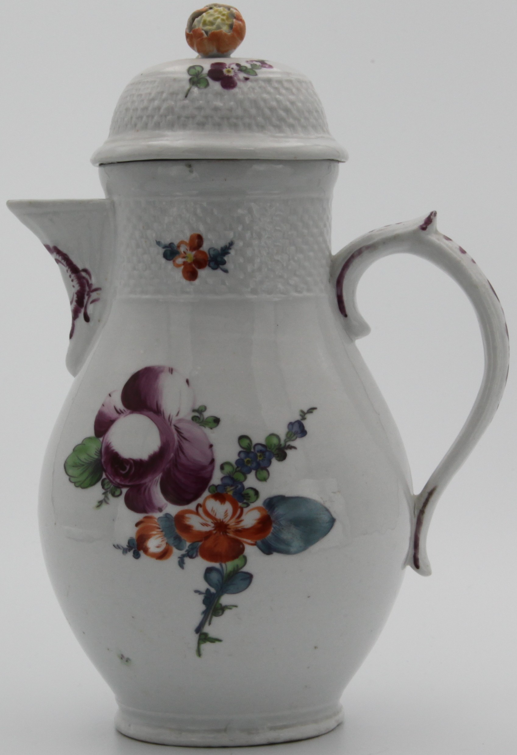 A Bristol porcelain chocolate pot and cover, with a band of basket moulding to both pot and cover, the cover with orange and yellow painted flower bud finial, painted in enamels with floral sprays, puce cross sword mark, Heavier Plymouth feel