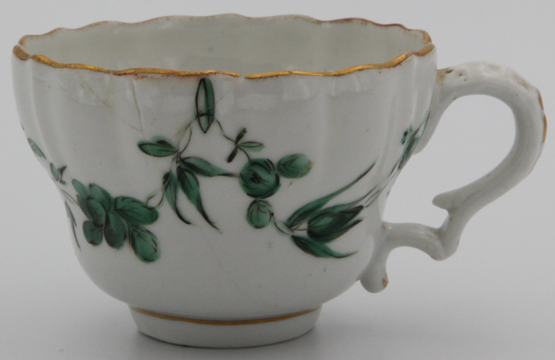 A mildly lobed Bristol coffee cup with green vine decoration, green garlands suspended from green loops hanging from gilt rim C1780. B mark