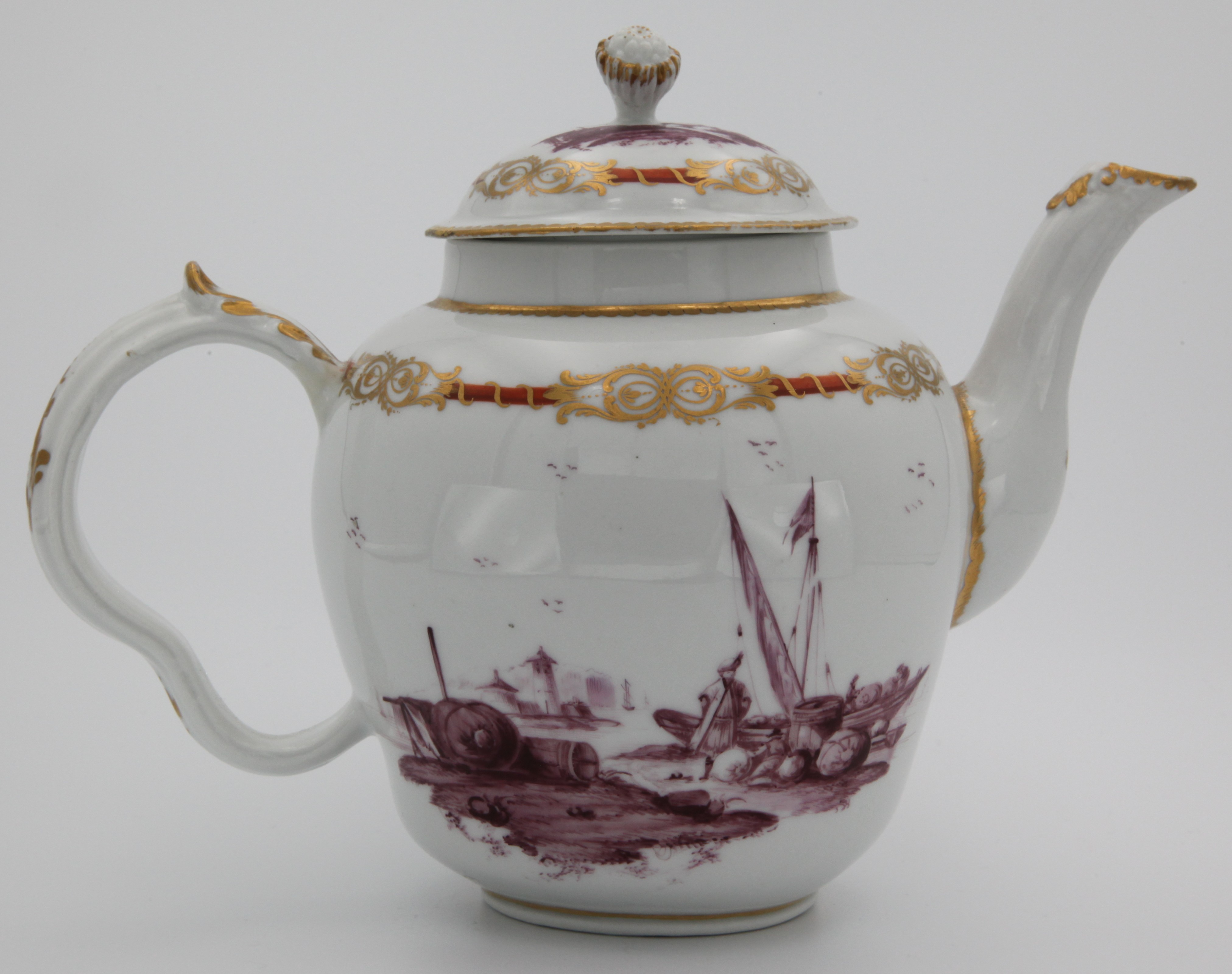 A fine Bristol ogee shaped teapot and cover, with flower and leaf knop, the ear shaped handle with leaf moulded thumbpiece, very finely painted in purple monochrome with figures and boats in estuary landscapes, within orange and gilt scroll and ribbon borders, gilt dentil rims, 6” high, circa 1775, no mark.  See F S Mackenna, Plymouth and Bristol Porcelain, page 110, number 69, for the spoon tray from this celebrated service
