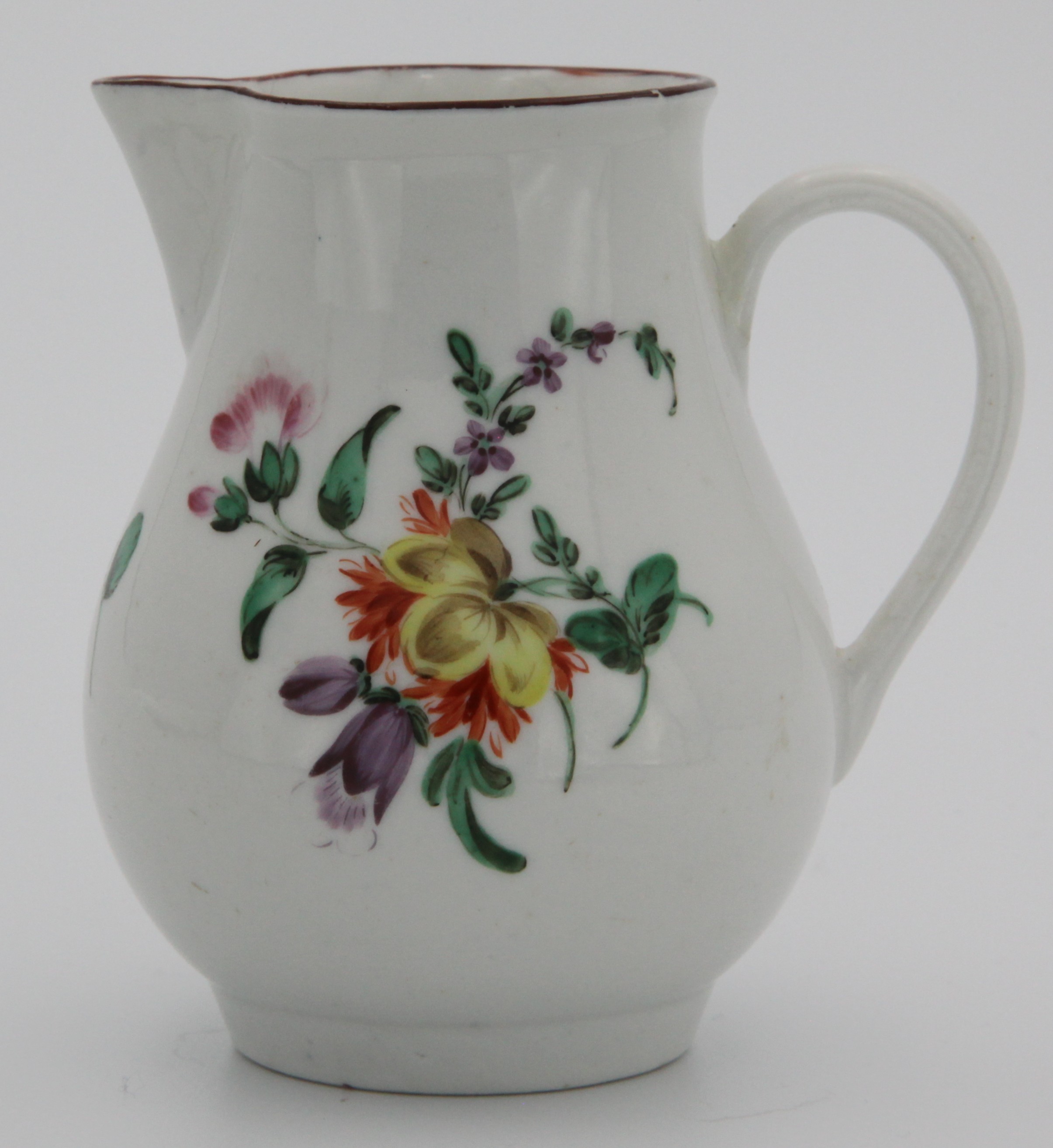 A small Bristol sparrow-beaked jug, with simple undecorated handle, painted with colourful floral spray and scattered flowers and with iron red rim. Faint X6 mark.