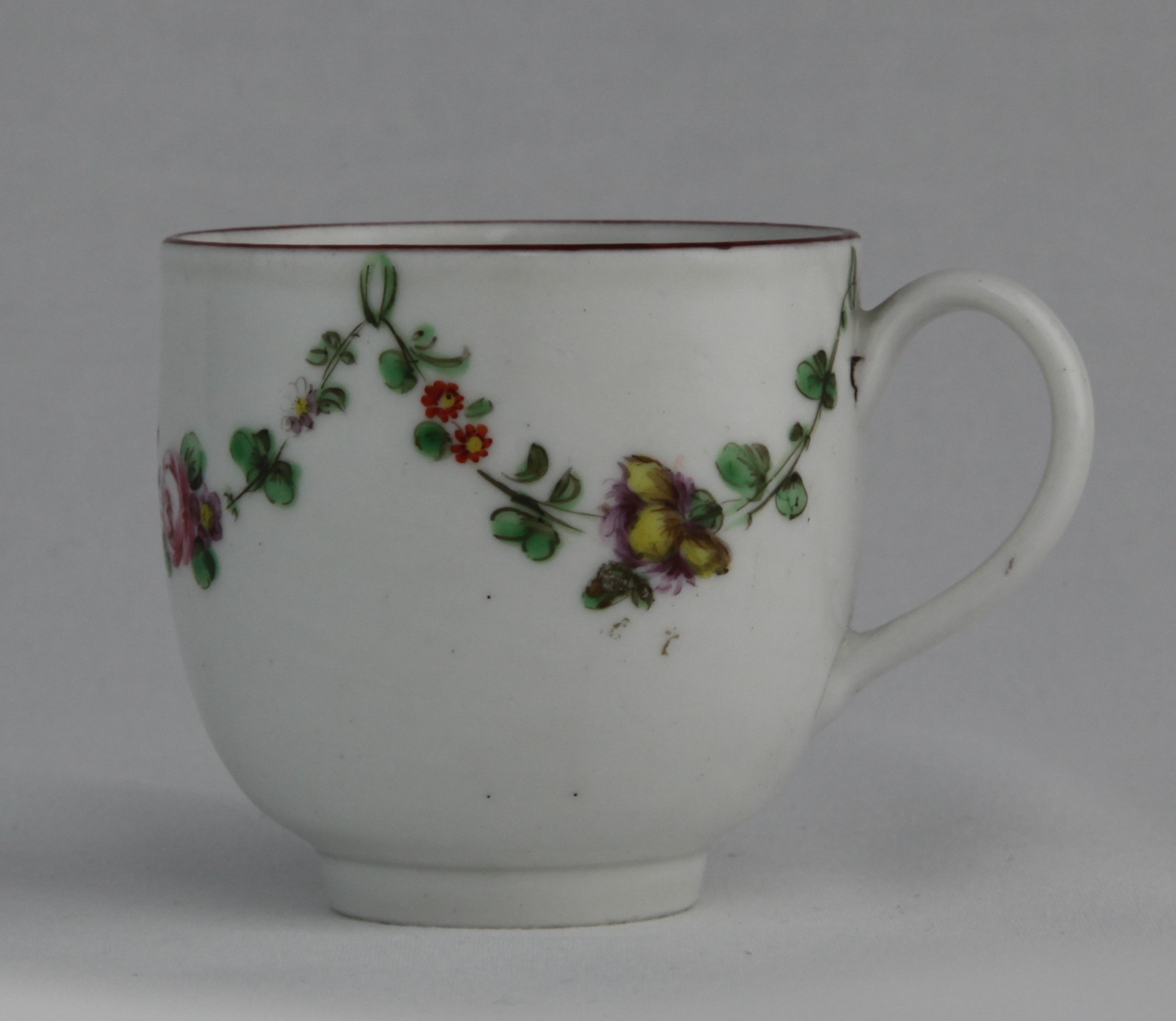 Cup, from the Green loop service, decorated by 16, A Bristol coffee cup with simple handle, painted in enamels with garlands of flowers suspended from green loops, iron red rim, blue X16 mark — Plymouth & Bristol porcelain piece 1331