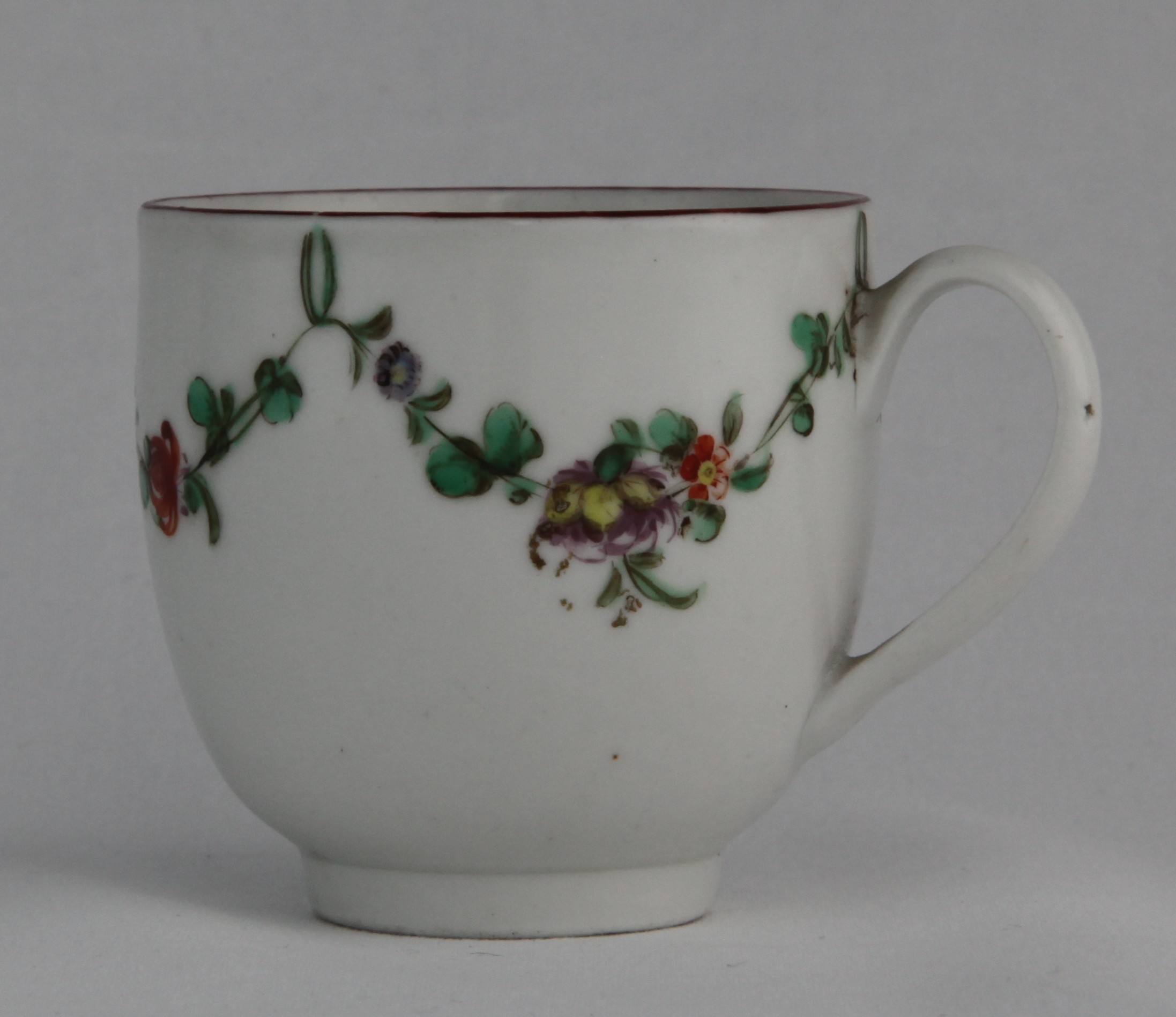 Cup, from the Green loop service, decorated by 16, A Bristol coffee cup with simple handle, painted in enamels with garlands of flowers suspended from green loops, iron red rim, blue X16 mark — Plymouth & Bristol porcelain piece 1332