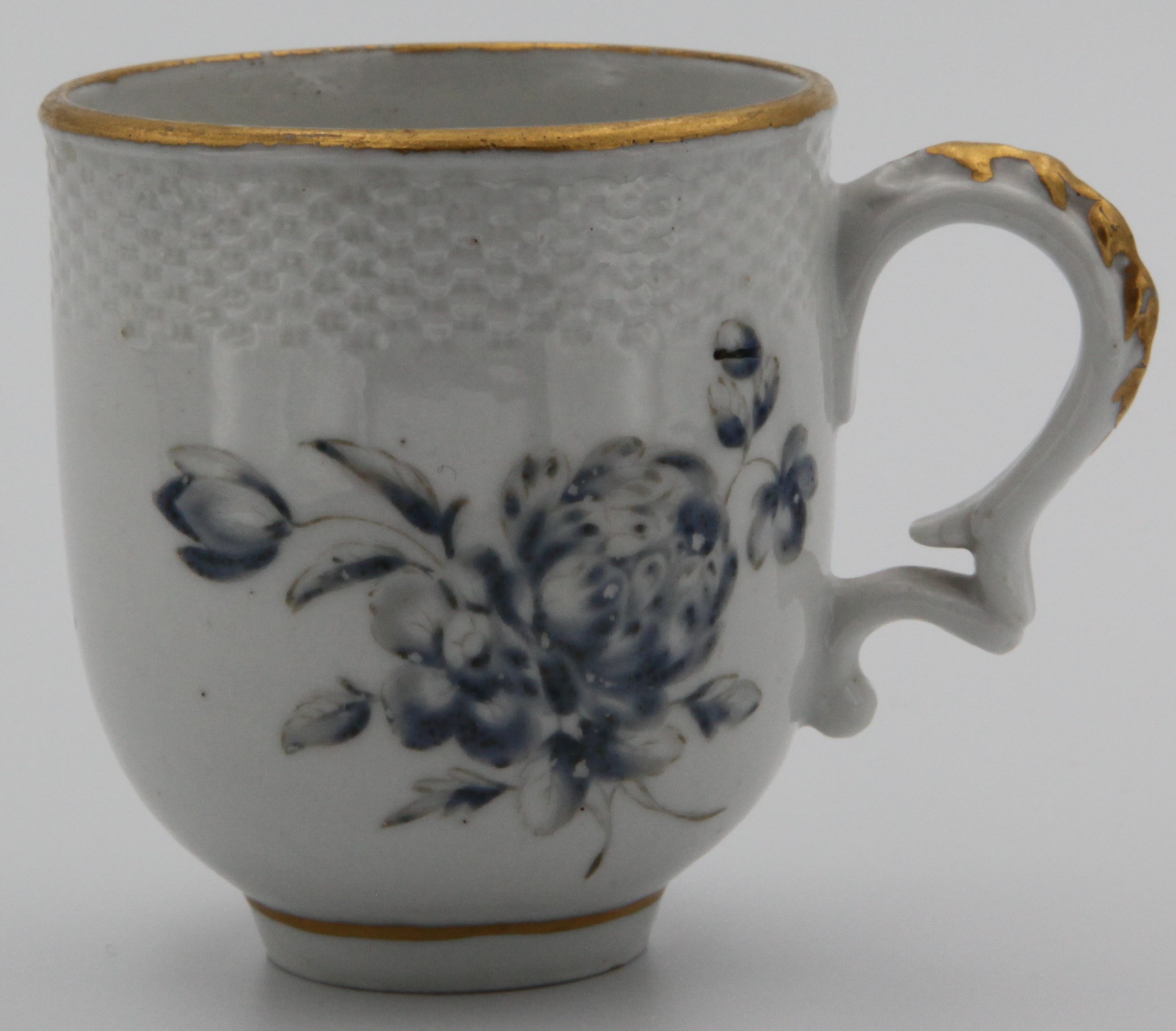 A rare Bristol porcelain coffee cup, from the Fry service, with harebell-moulded ear-shaped handle, painted in delicate pale "dry blue" enamel by William Stephens with a flower spray and scattered flowers, beneath a basket-moudled band, gilt line rim,  circa 1775, blue painted X mark and numeral 5. See FS Mackenna, Plymouth and Bristol Porcelain, number 96, for the cream jug from this service, probably made for Joseph Fry, Quaker friend and financial backer of Champion. A tea cup from this serrvice was in the Peter Stephens collection