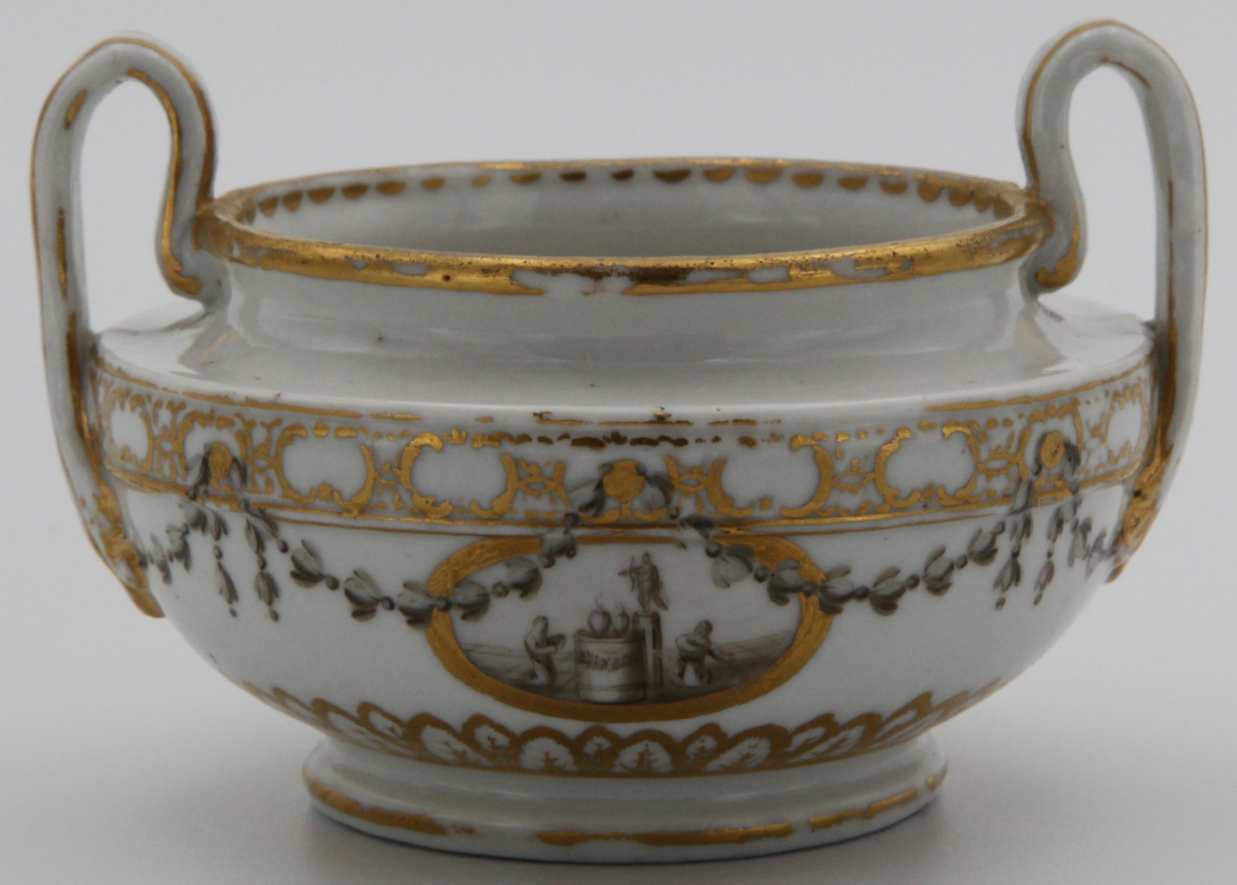 One of a rare pair of Bristol porcelain two-handled pots or vases, c.1772-75, the squat Etruscan forms painted with en grisaille panels of figures flanking garden statuary and hearts, within monochrome husk garlands and formal gilt borders, blue X marks. This pair decorates the title page of Hugh Owen's Two Centuries of Ceramic Art in Bristol.