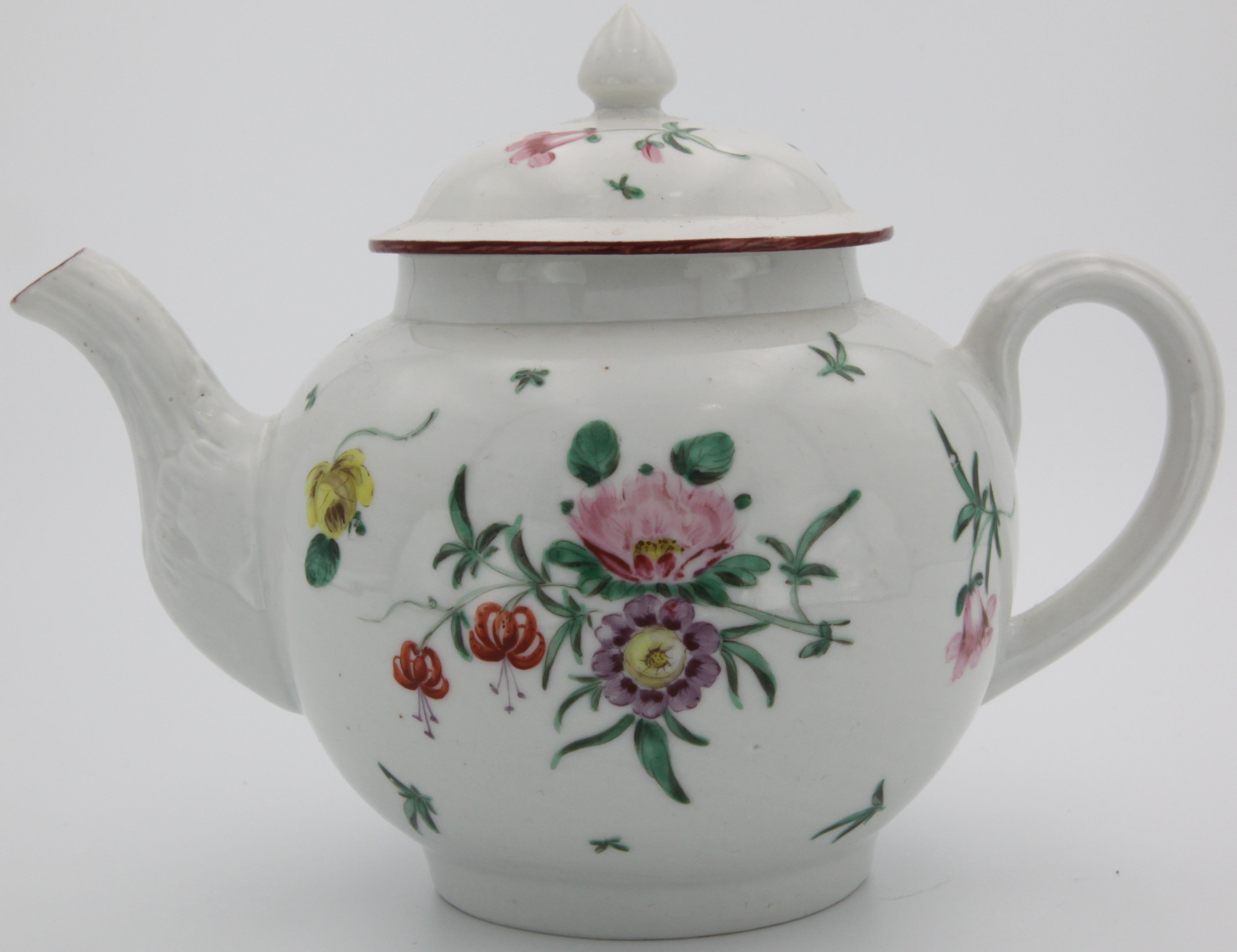 A Bristol teapot and domed cover with conical finial, with plain ridged handle, and moulded ridged spout, painted in enamels with sprays of pink purple and two orange flowers to front and back and with scattered leaves and flowers, under an iron red rim line. Circa 1775, Blue X11. mark