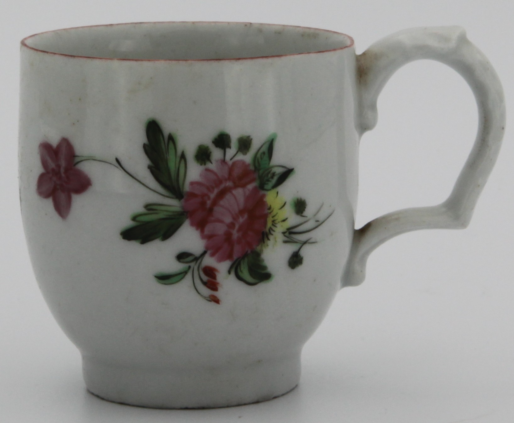 A Bristol (?) coffee cup with moulded handle painted with flowers under a brown line border  c. 1775-78.