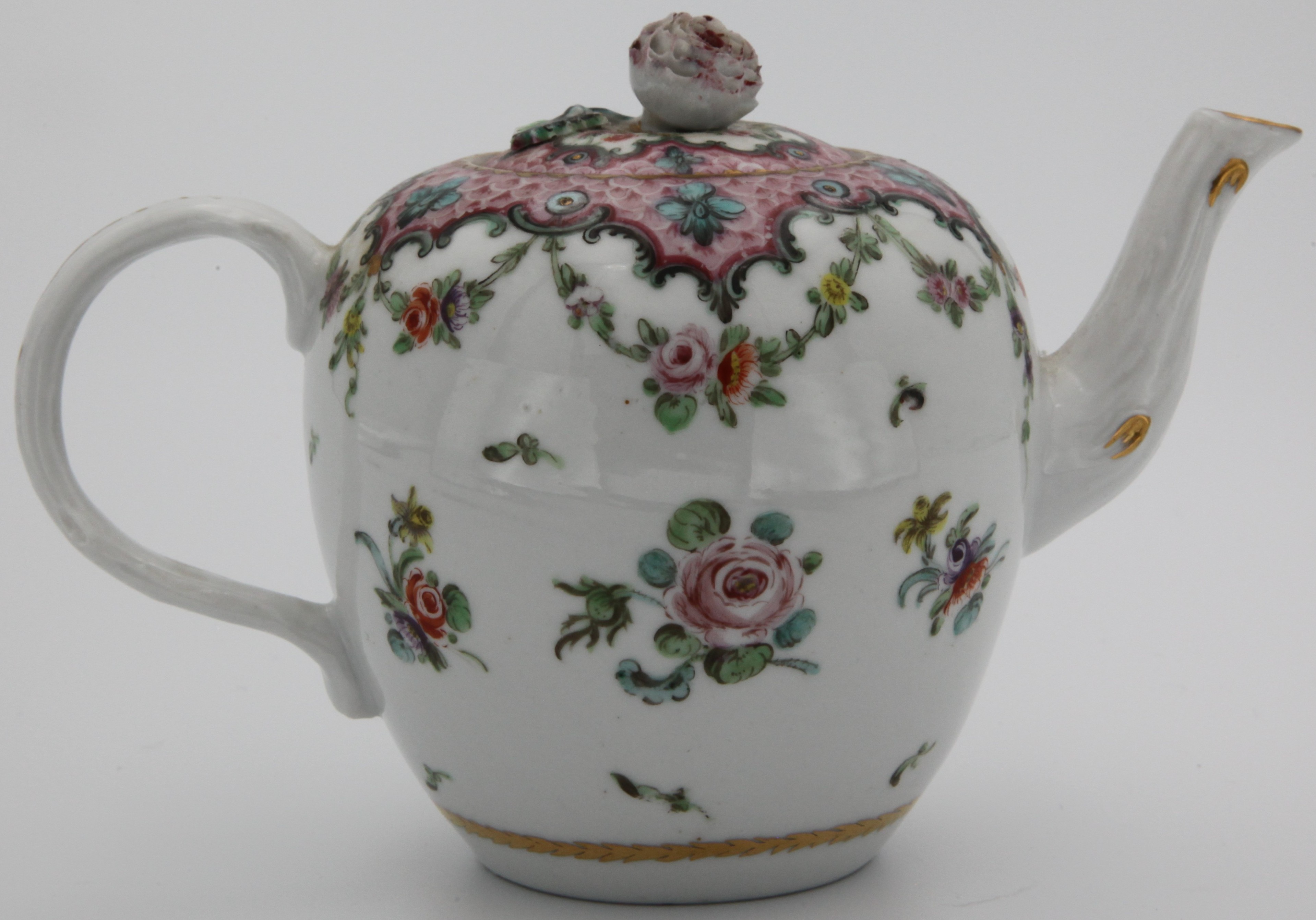 An ovoid teapot and cover, from a rare Bristol cabaret set, with crabstock handle and spout, and flower knop, painted in coloured enamels with scattered flowers, within a pink scale border, with green ‘C’ scrolls and flower heads, suspending garlands of flowers and leaves.