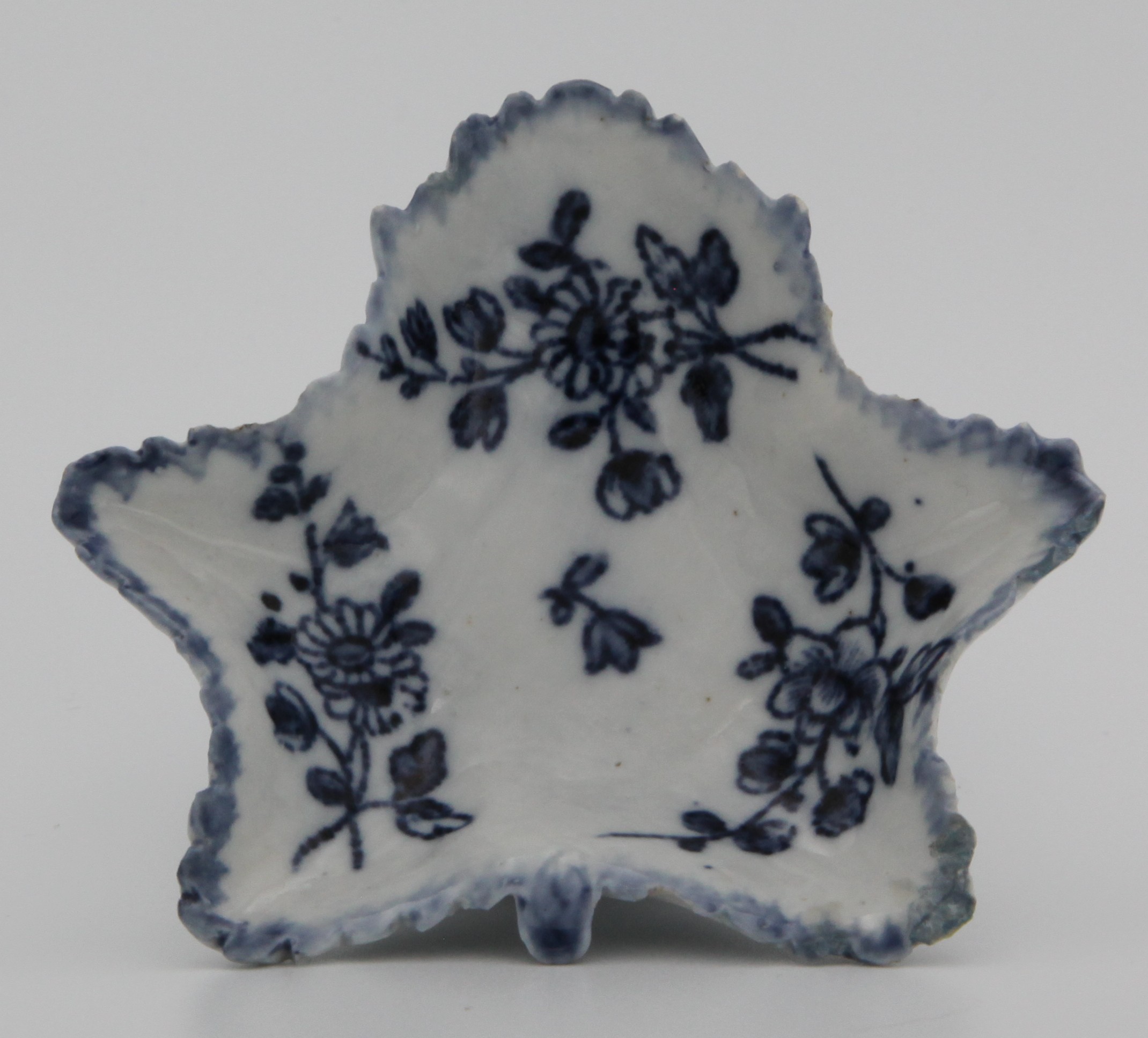 A Bristol blue and white leaf shaped pickle dish, circa 1775, painted with floral sprays and a light blue feathered border.