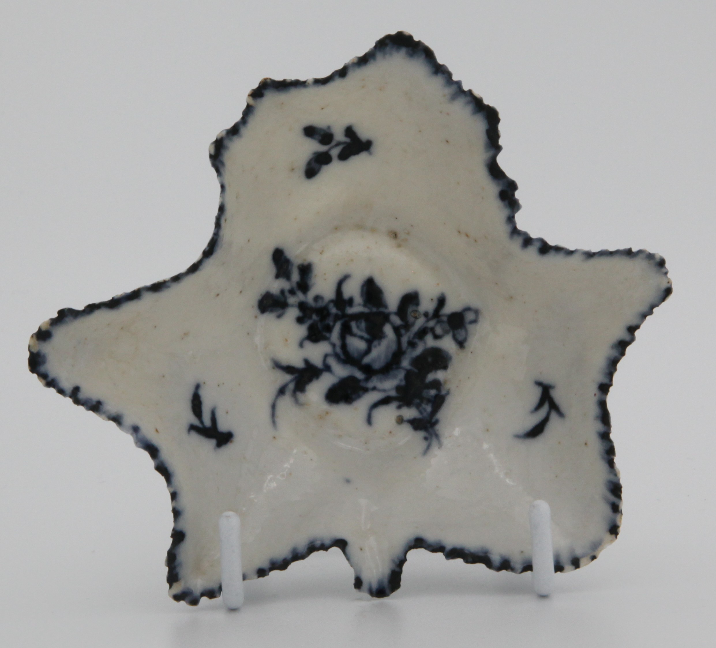 A Bristol blue and white leaf shaped pickle dish, circa 1775, painted with floral sprigs, X mark to base.