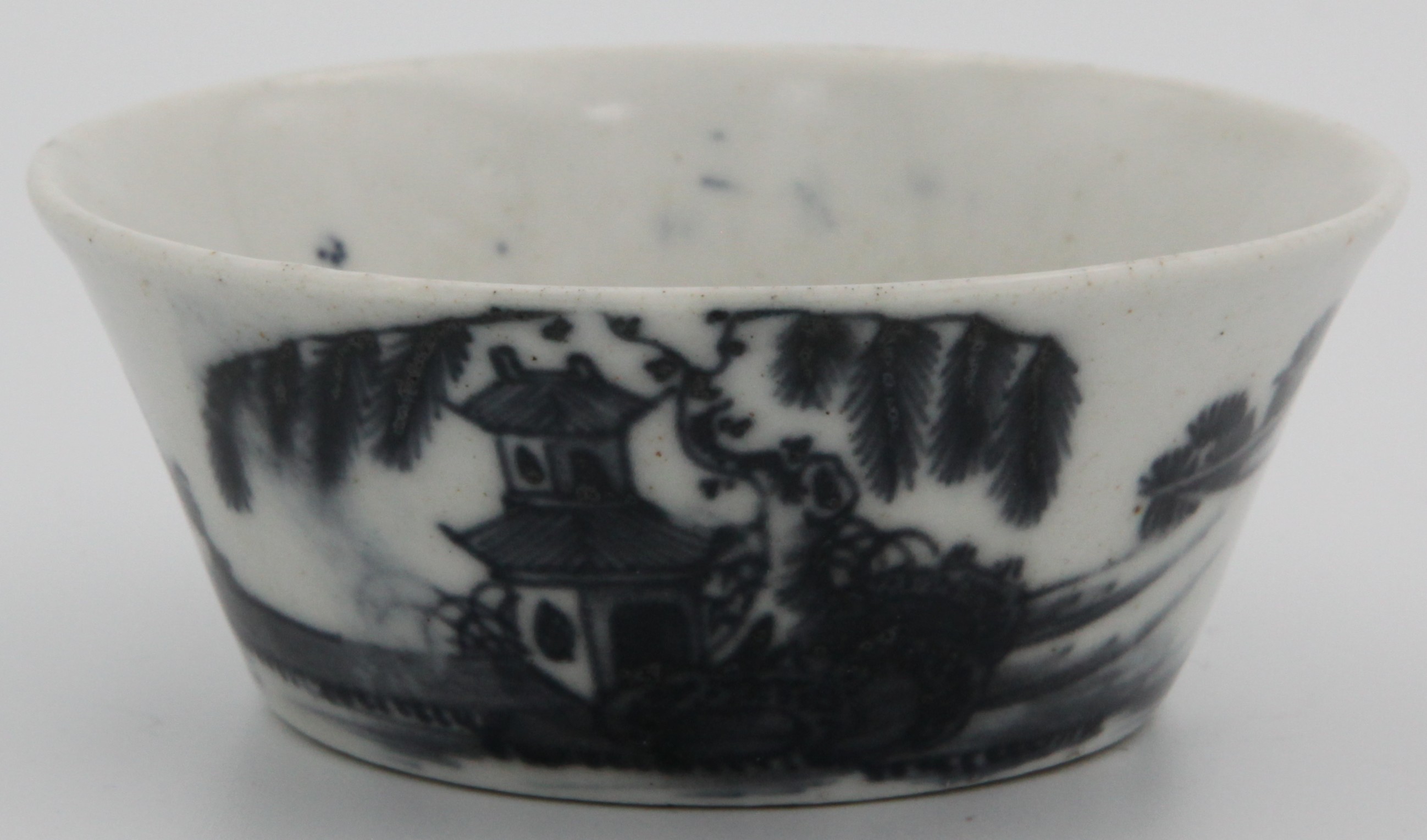 A rare Plymouth blue/white porcelain bowl, the tapering sides with chinoiserie blue underglaze decoration, depicting temple and hut in rural mountain setting, tin mark in underglaze blue on the base. 1768-1770