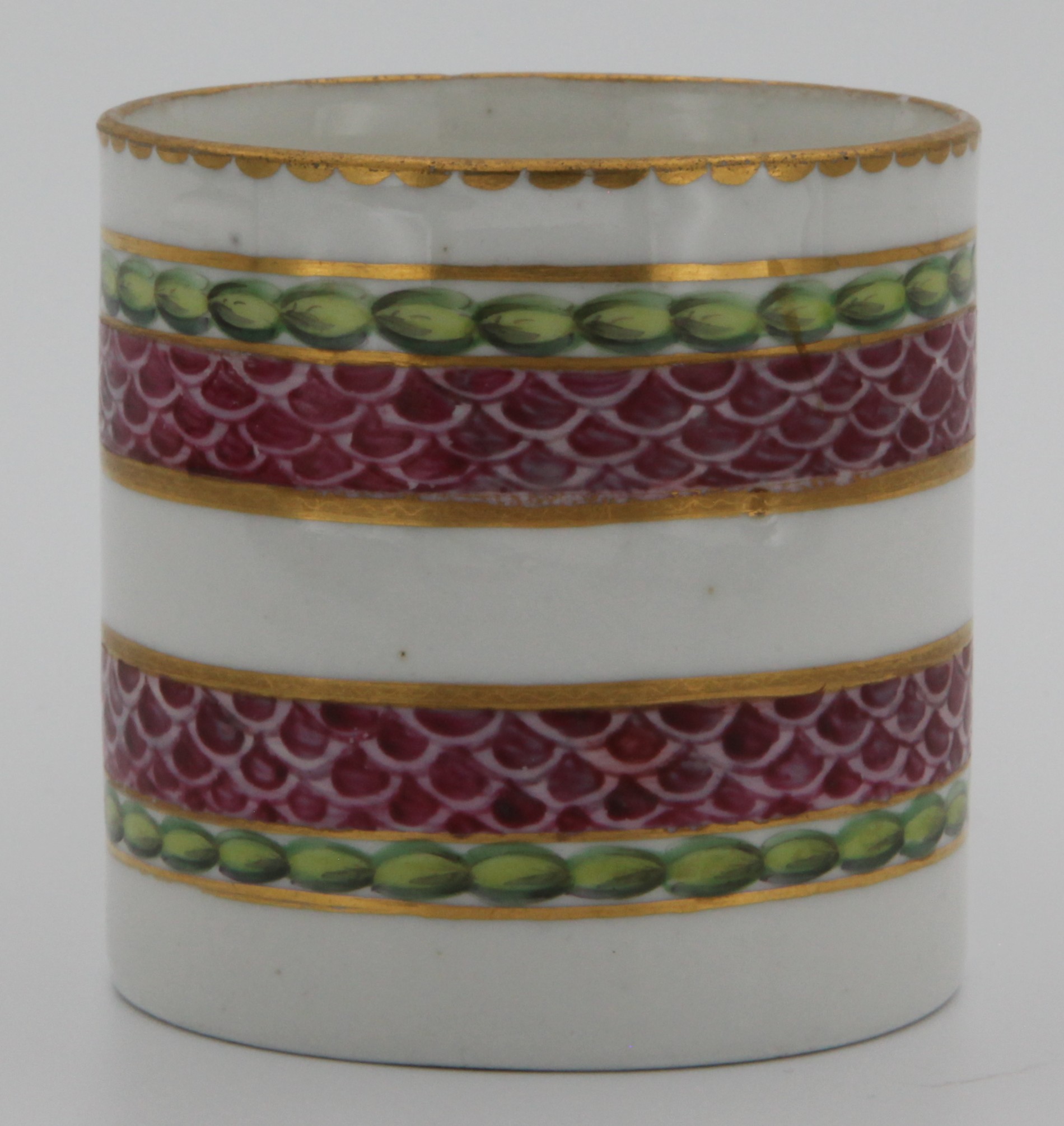 A fine Bristol coffee can  with harebell moulded scroll handle, painted in pink with scale bands, within green laurel borders, gilt dentil rims, circa 1775, blue painted X on cup. See Albert Amor Limited, The Alfred Trapnell Collection, 1912, numbers 27 and 28 for similar examples