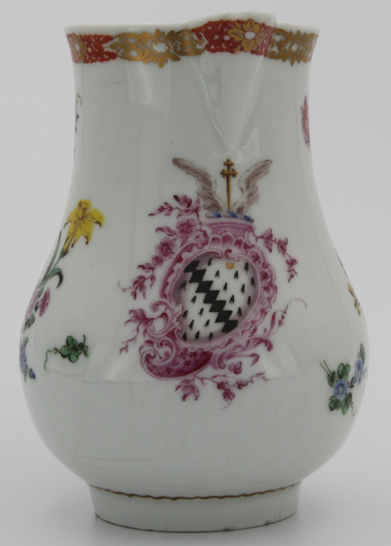 Bristol armorial jug finely painted with the arms of Pye of Faringdon, a shaped shield of Ermine a bend indented gules within a puce rococo border, the crest a cross crosslet between wings, flanked by flower sprays, the grooved handle with elaborate gilt borders. The two most likely members of the Pye family for whom this jug might have been made are Admiral Sir Thomas Pye (c.1708/9-1785) who served during the American Wars of Independence; and Henry James Pye (1745-1813), MP for Berkshire and Poet Laureate from 1790.