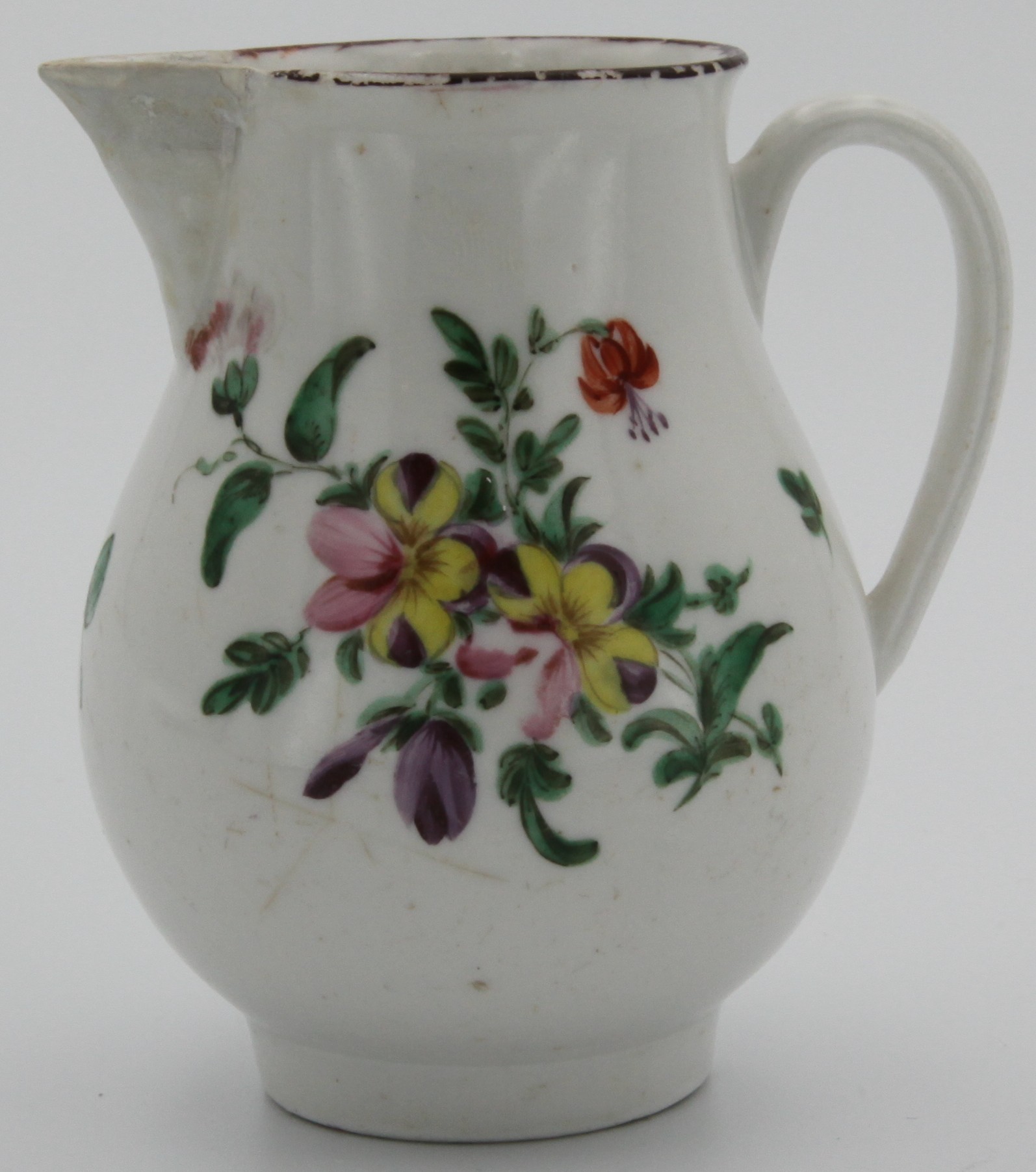 A Bristol sparrow beak jug, painted in enamels with a colourful spray of summer flowers, and scattered leaves and flowers, brown rim line, blue X15. mark, c.1770