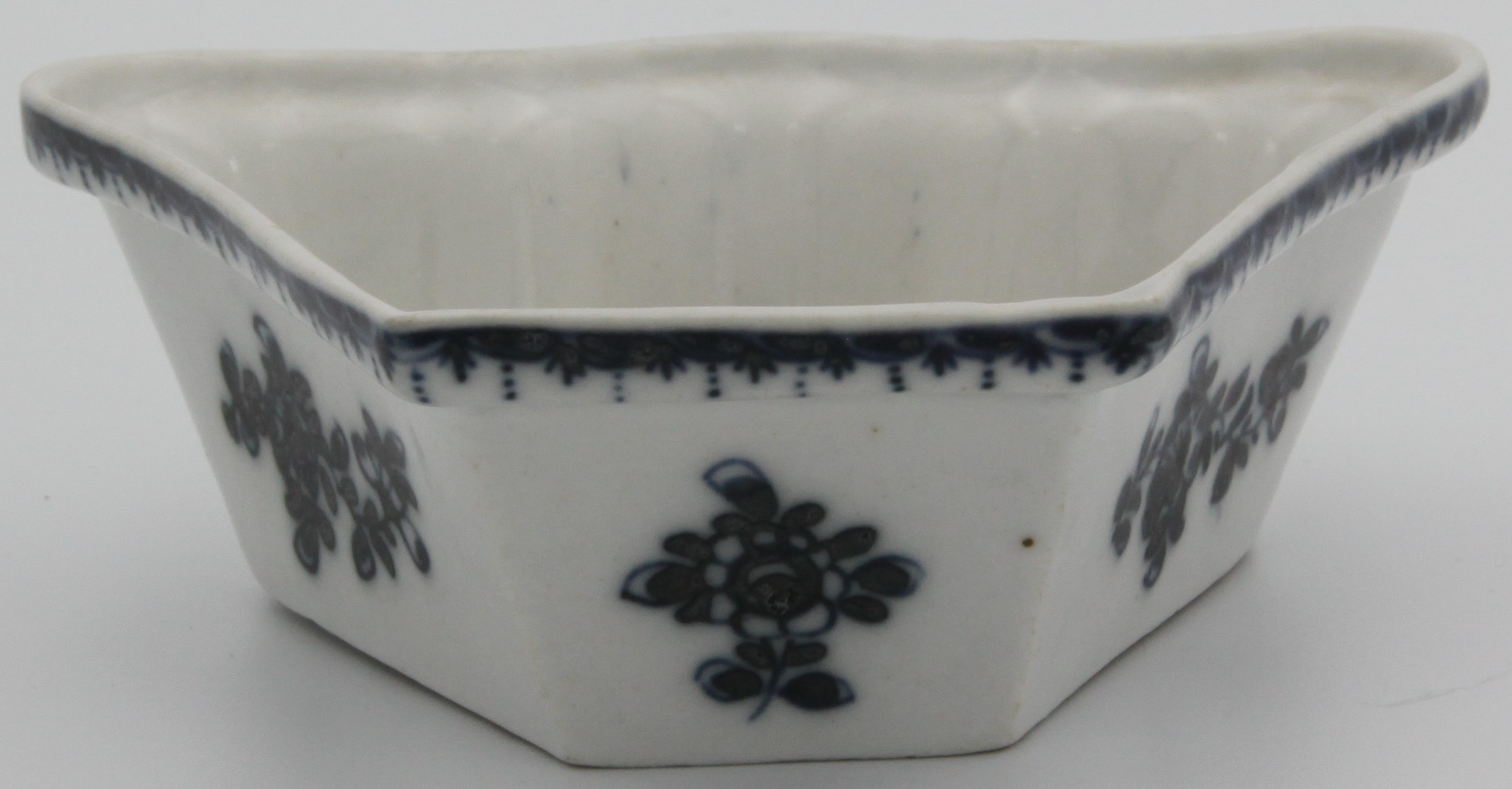 A Plymouth blue and white hors d'oeuvres dish,  the fan-shaped dish painted to the exterior with small flowering sprigs, the rim with a berried border, no mark, c.1768-70