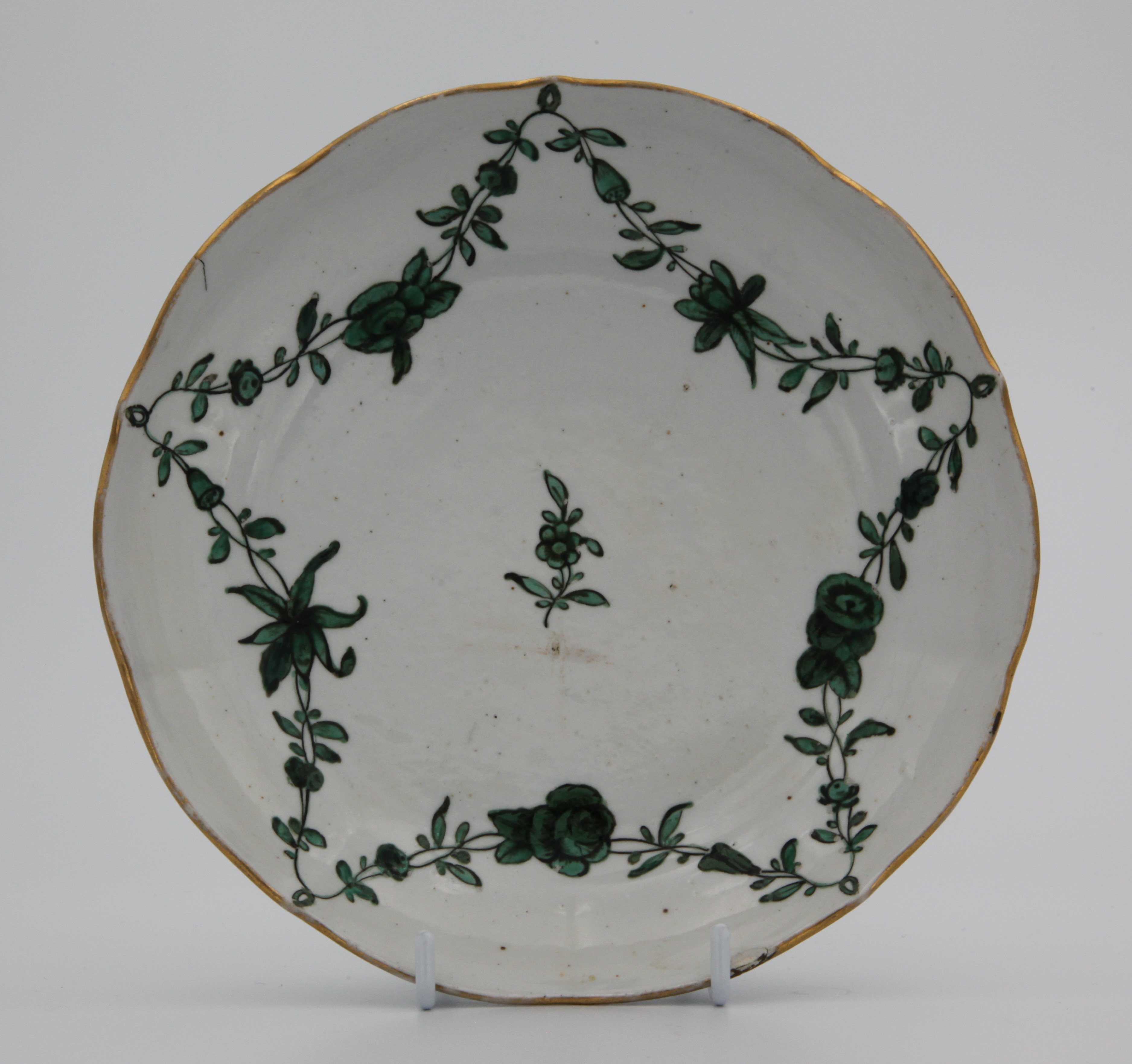 Dish, from the Green Monochrome - green loops service, decorated by No mark, A Bristol dish of ogee shape and slight lobed form, painted in enamels with monochrome green garlands of flowers and leaves suspended from green loops hanging from a gilt rim line — Plymouth & Bristol porcelain piece 1472