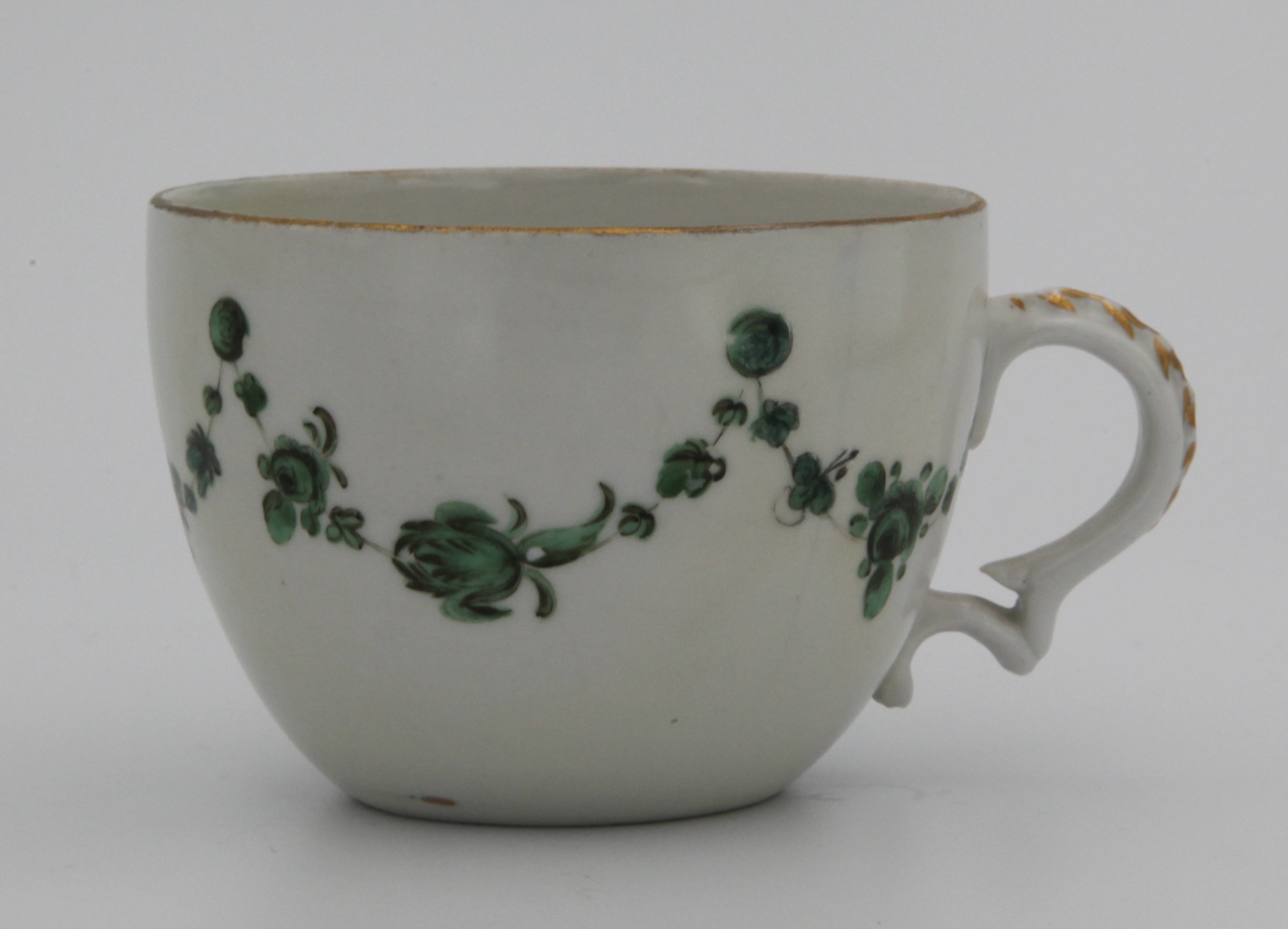 Cup, from the Green roundels service, decorated by 8, A Bristol teacup of rounded shape and with moulded scroll handle,  painted in enamels with monochrome green garlands of flowers and leaves suspended from green roundels below from a gilt rim line — Plymouth & Bristol porcelain piece 1478