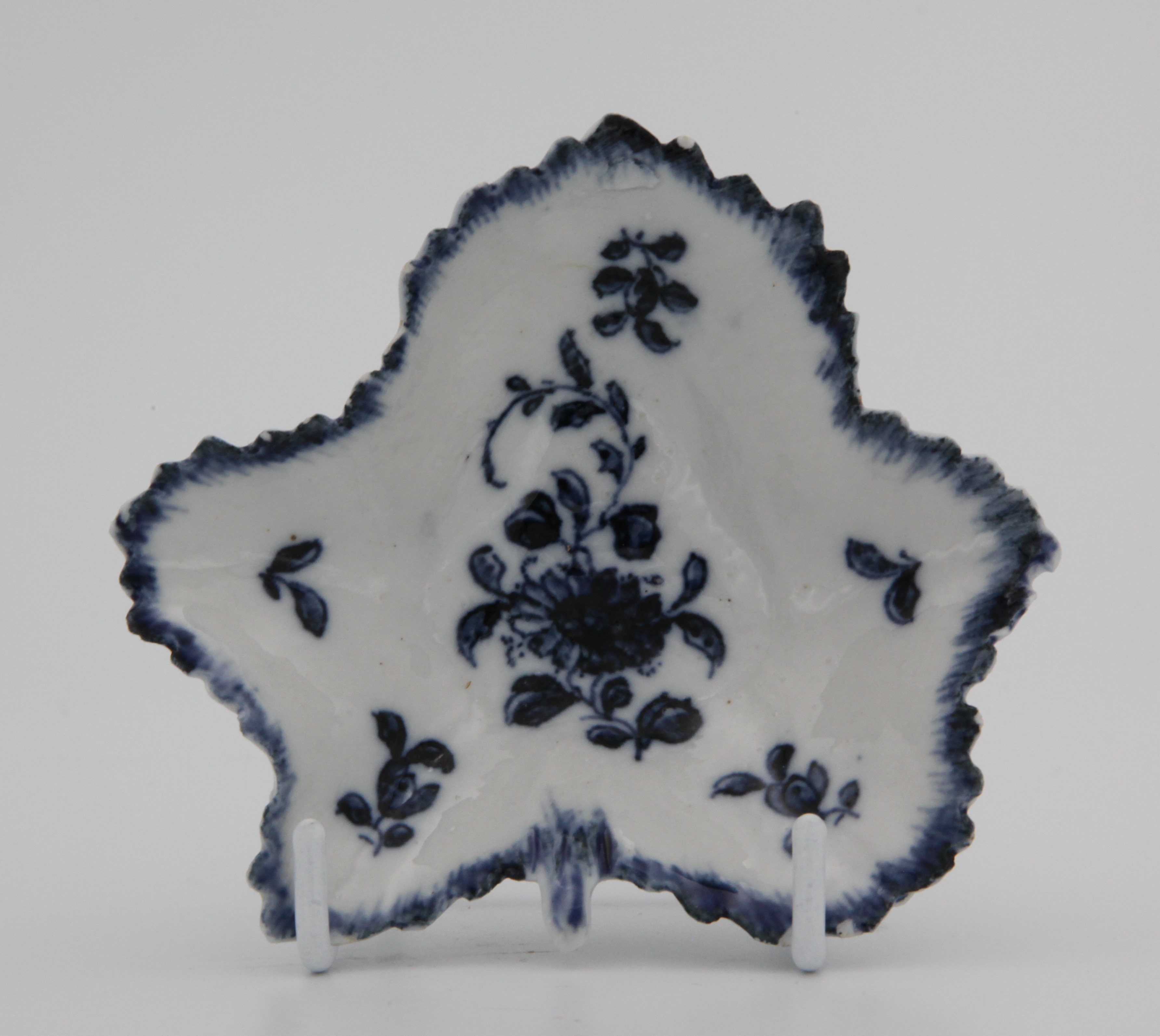 A Bristol blue and white leaf shaped pickle dish, circa 1775, painted with floral sprigs, X mark to base, 10cm across