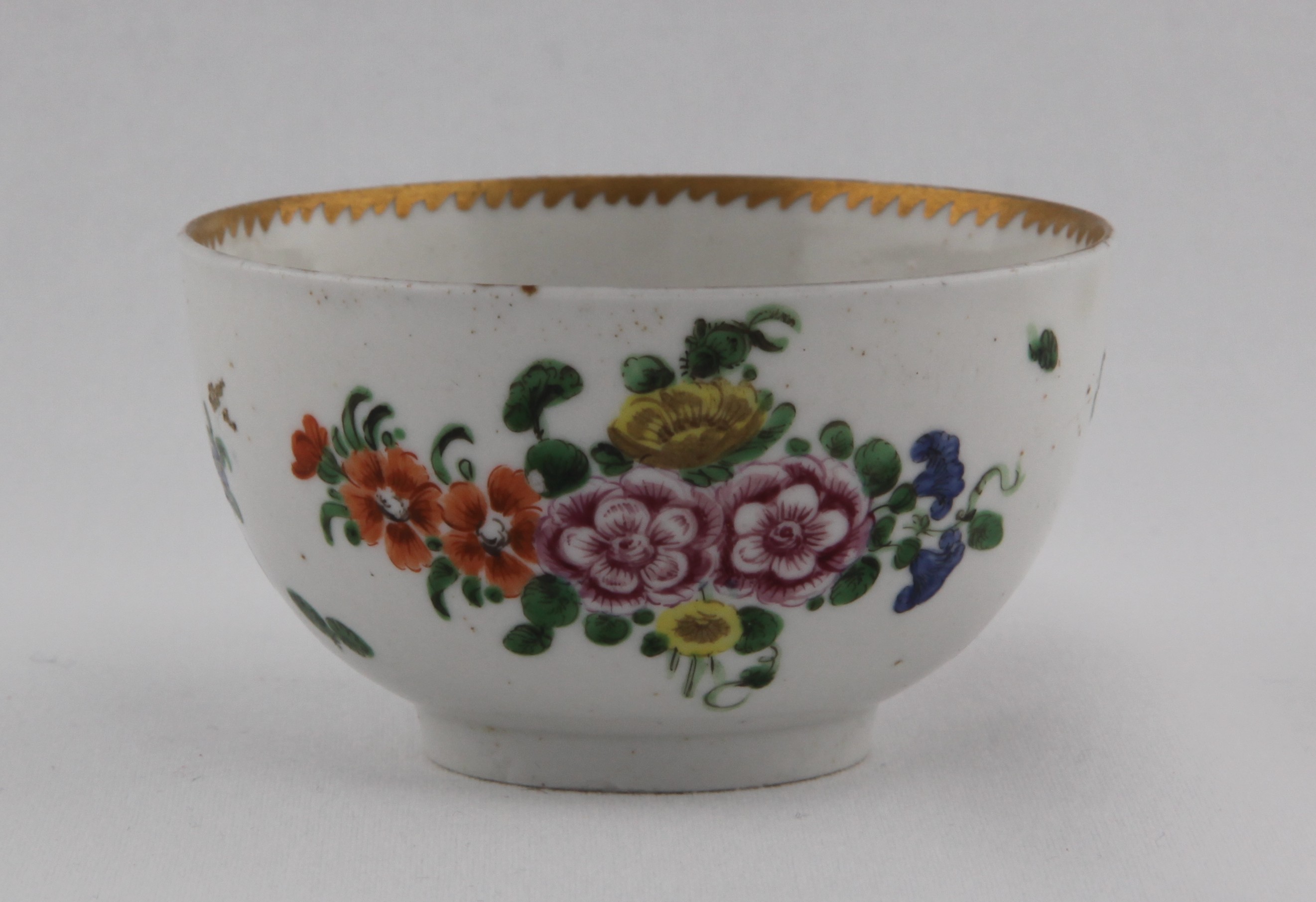 Cup, from the Gilt dentil rim free sprays service, decorated by No mark, A Bristol teacup, with plain, gilt-decorated handle, painted in enamels with a two bouquets of colourful flowers, scattered sprays and leaves, angular gilt dentil rim line to the inside — Plymouth & Bristol porcelain piece 1494