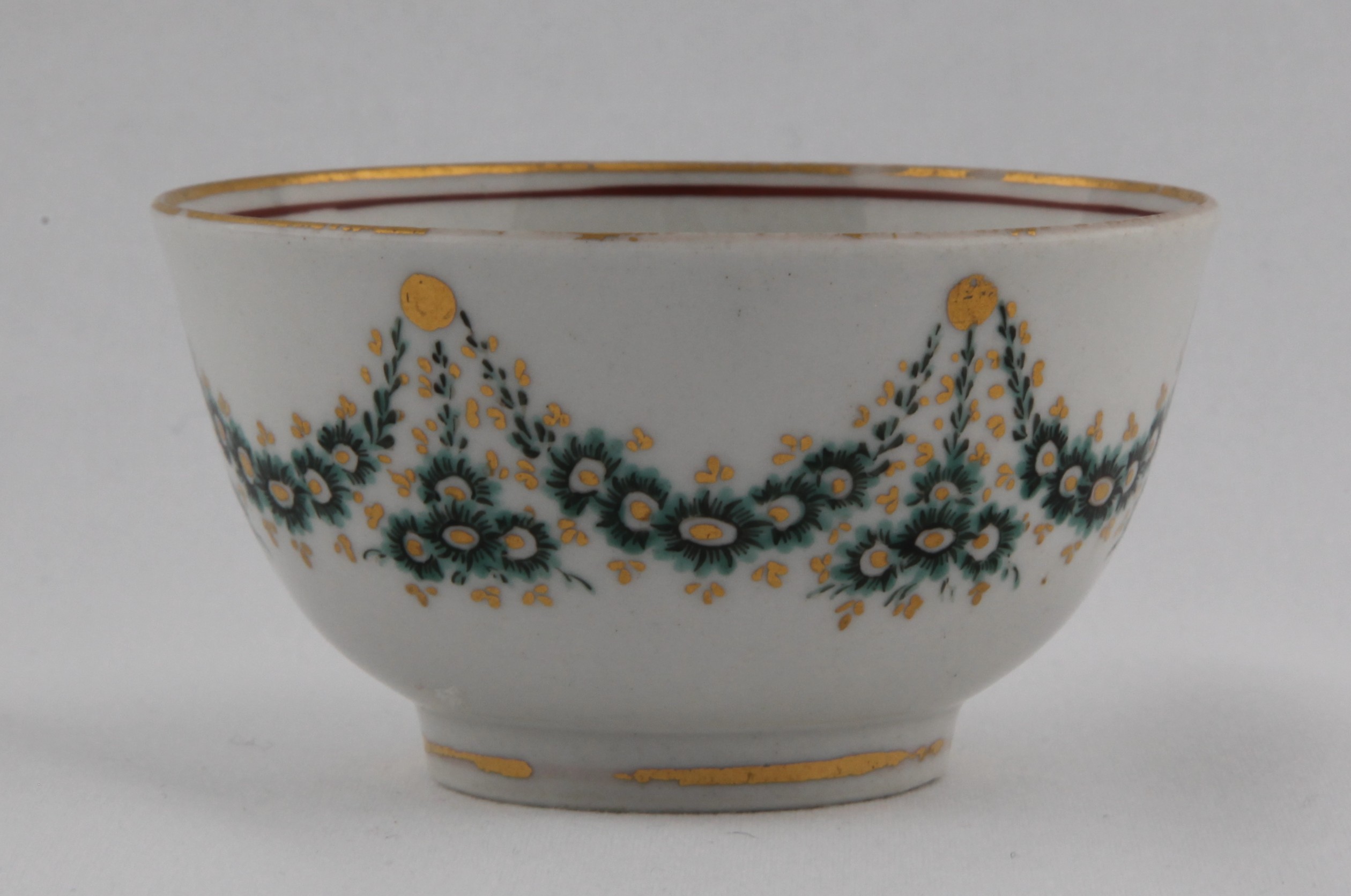 Tea bowl, decorated by No mark, A Bristol tea bowl, slightly everted, with unusual garlands of green and gilt flowers suspended from gilt roundels under a gilt rim line — Plymouth & Bristol porcelain piece 1495