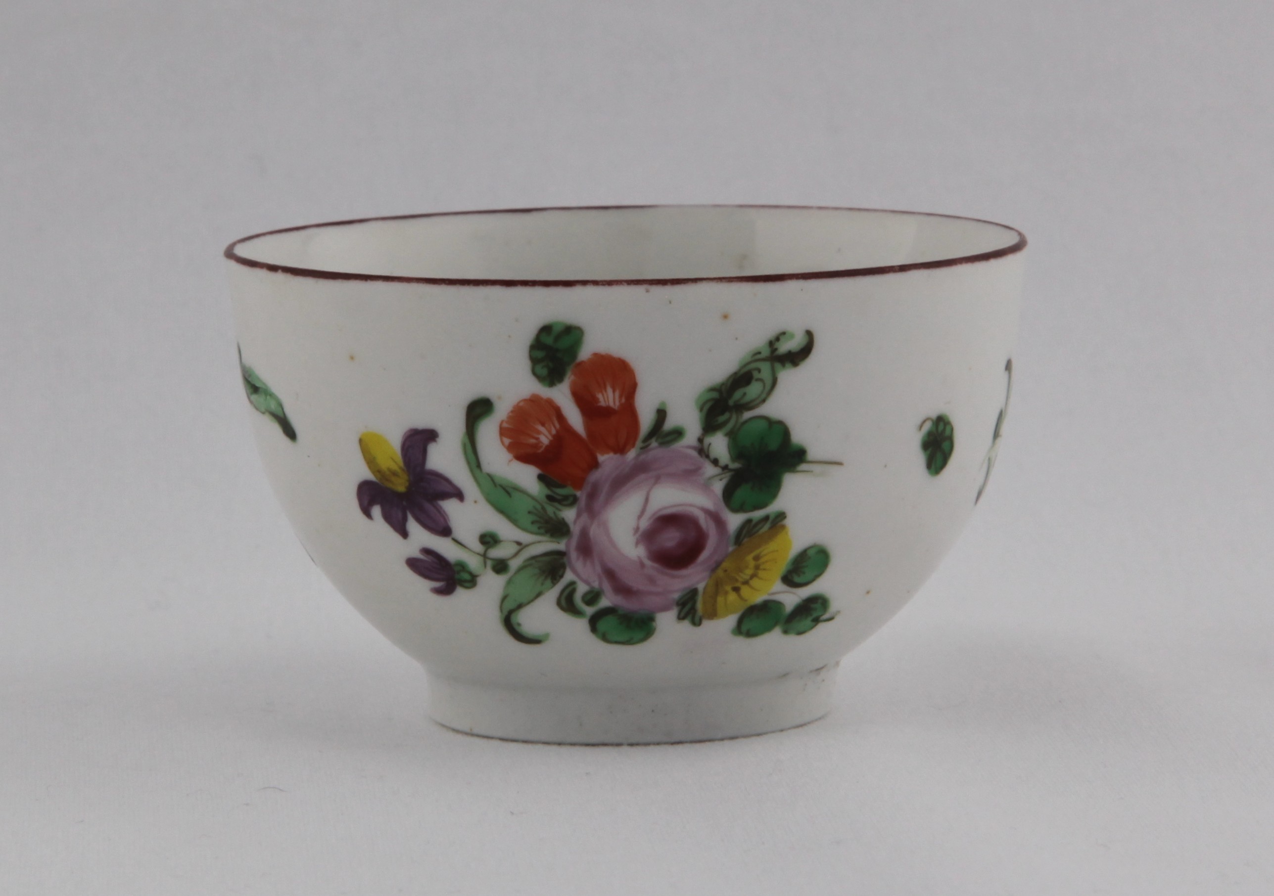 Tea bowl, from the Cottage Bristol service, decorated by No mark, A Bristol tea bowl of rounded shape painted in enamels with a bouquet of flowers and scattered leaves under iron red rim line — Plymouth & Bristol porcelain piece 1497