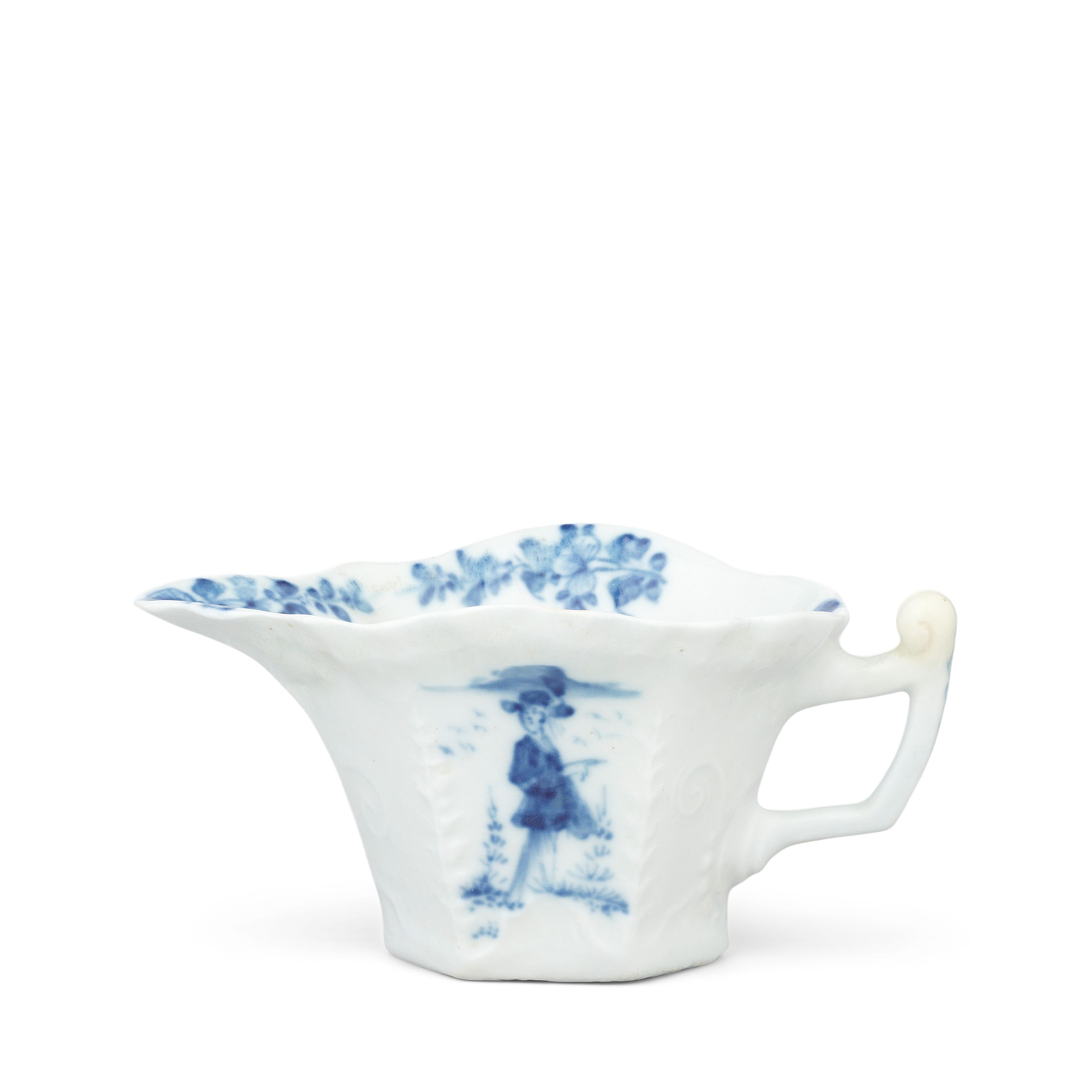 A rare Lund's Bristol creamboat, circa 1750 of flared hexagonal form with a shaped rim, the angular handle with an upturned thumbrest, delicately moulded with a geranium leaf below the lip, a feuilles-de-choux border below the rim, and scrolls around the base and handle, painted in blue on both sides with a 'Long Eliza' figure flanked by trees and birds, flower sprays to the interior, 11.1cm long