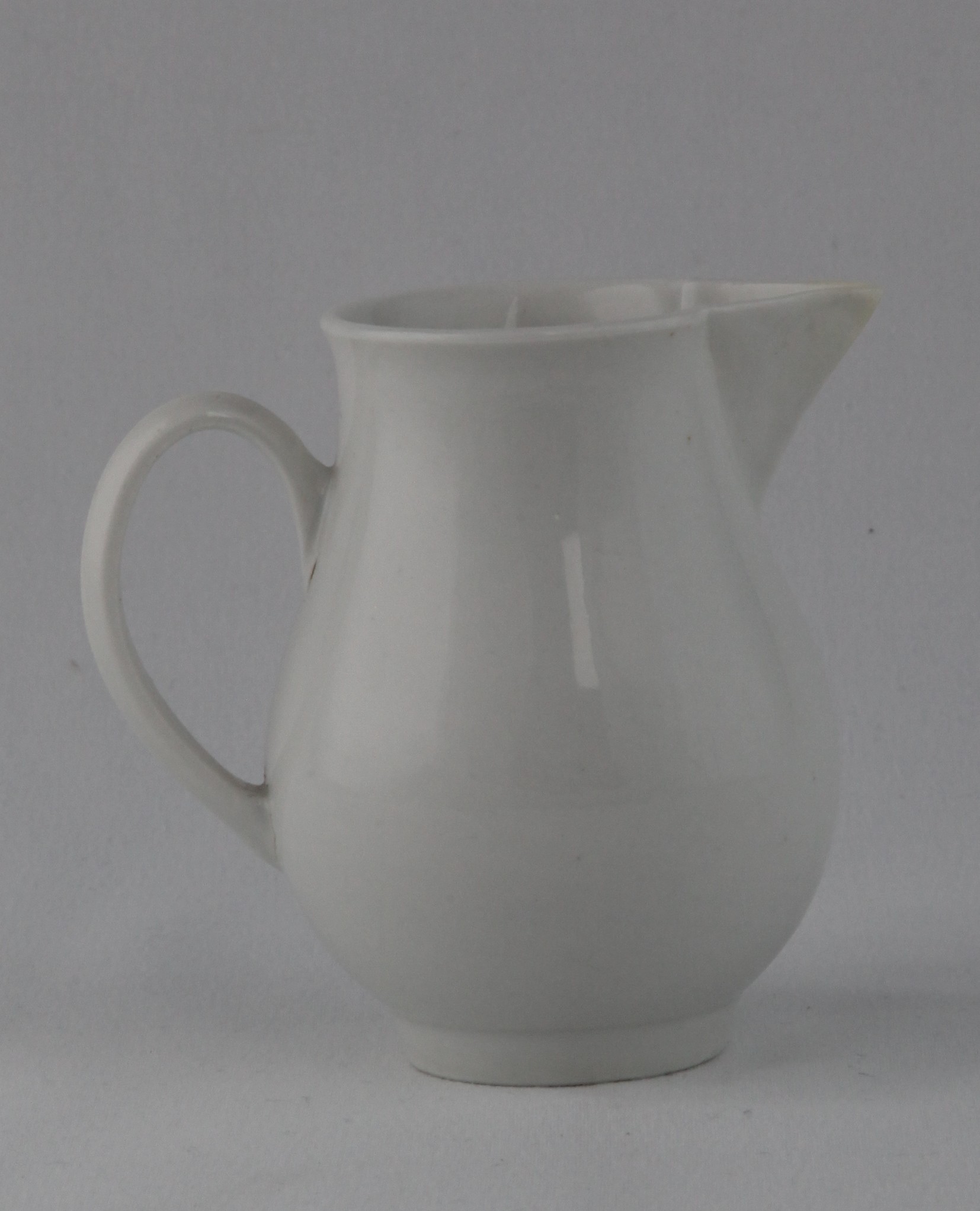 A Bristol baluster shaped sparrow beak cream jug, with loop handle, in the white, 3 3/8" high, circa 1775, no mark