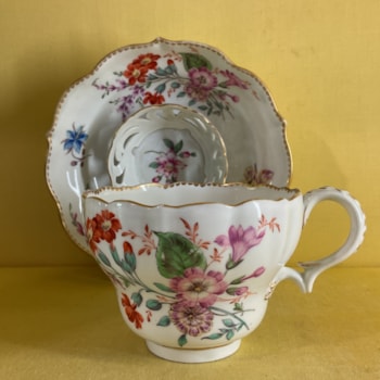 A rare Bristol ogee shaped chocolate cup with laurel moulded loop handle, particularly finely painted in coloured enamels with sprays of flowers and leaves, and scattered flowers, within gilt dentil borders, 5 1/2" diameter overall, circa 1775, B7 mark in blue enamel