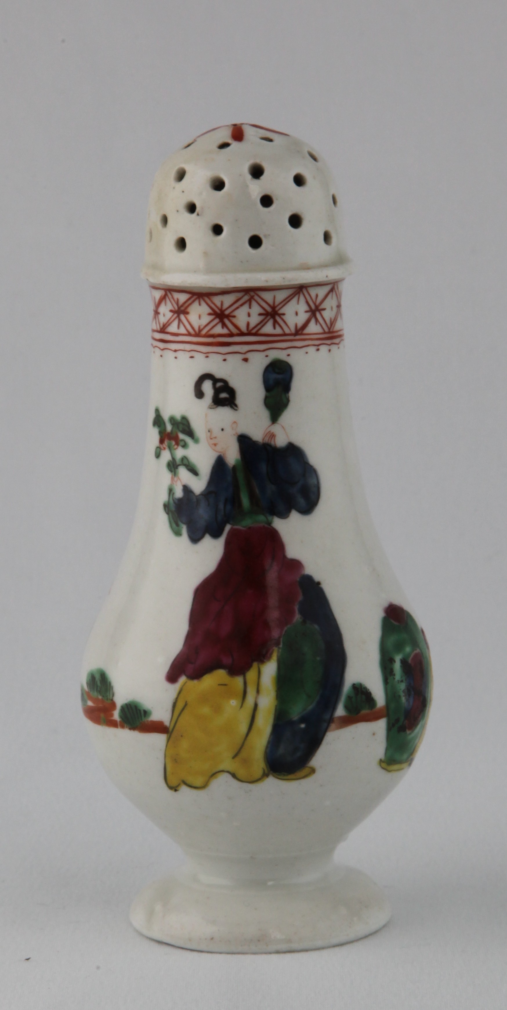 An extremely rare Plymouth baluster shaped castor, boldly painted in coloured enamels in Chinese famille verte palette with a mother and child in a continuous landscape with vases and a stand, beneath an iron red diaper band, 5 3/4" high, circa 1770, no mark