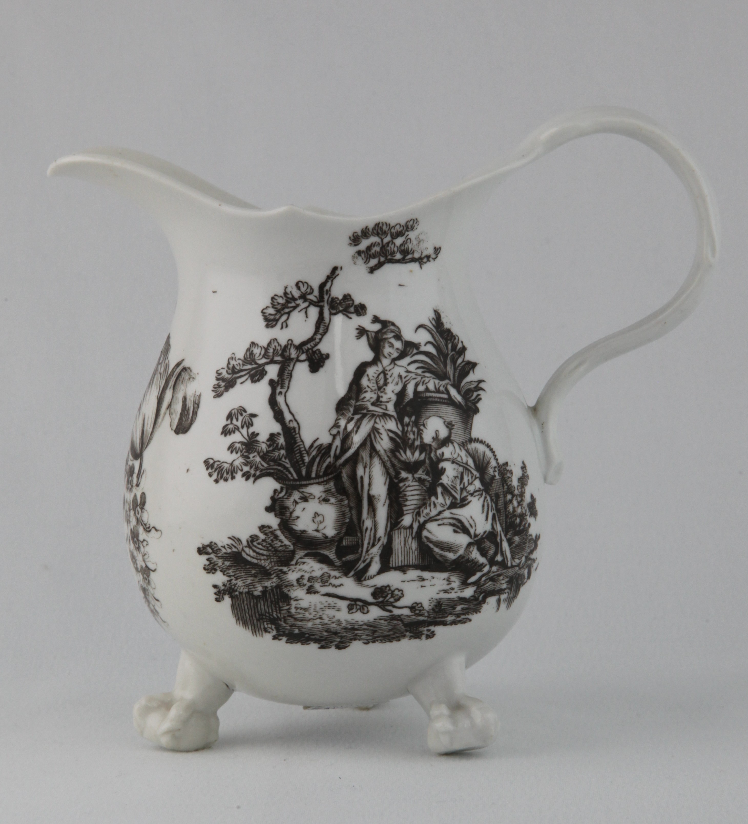 An extremely rare Bristol large baluster shaped milk jug, after a silver original, with crabstock loop handle, printed in black from an engraving by Robert Hancock with La Terre and two flower sprays, on three claw and ball feet, 5" high, circa 1775, no mark.