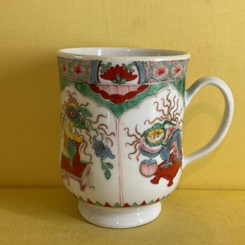 A Plymouth baluster shaped mug, with notched loop handle, painted in Chinese famille verte palette with the Dragon in Compartments pattern, 4 1/4" high, circa 1770, painted tin mark in red