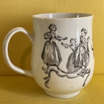 A rare Bristol baluster shaped mug, with notched loop handle, printed in black after Hubert Gravelot with 'Blind Man's Buff' and 'Battledore and Shuttlecock', flanking a spray of flowers and leaves, 3 3/4" high, circa 1772-75, no mark.