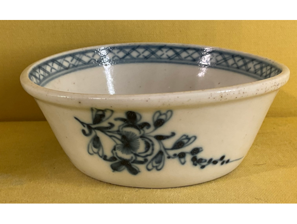 A Bristol small flared round patty pan, the exterior painted in underglaze blue with trailing sprays of flowers and leaves, the interior painted with a flower, within a diaper band, 3 1/2" diameter, circa 1775, blue painted X mark