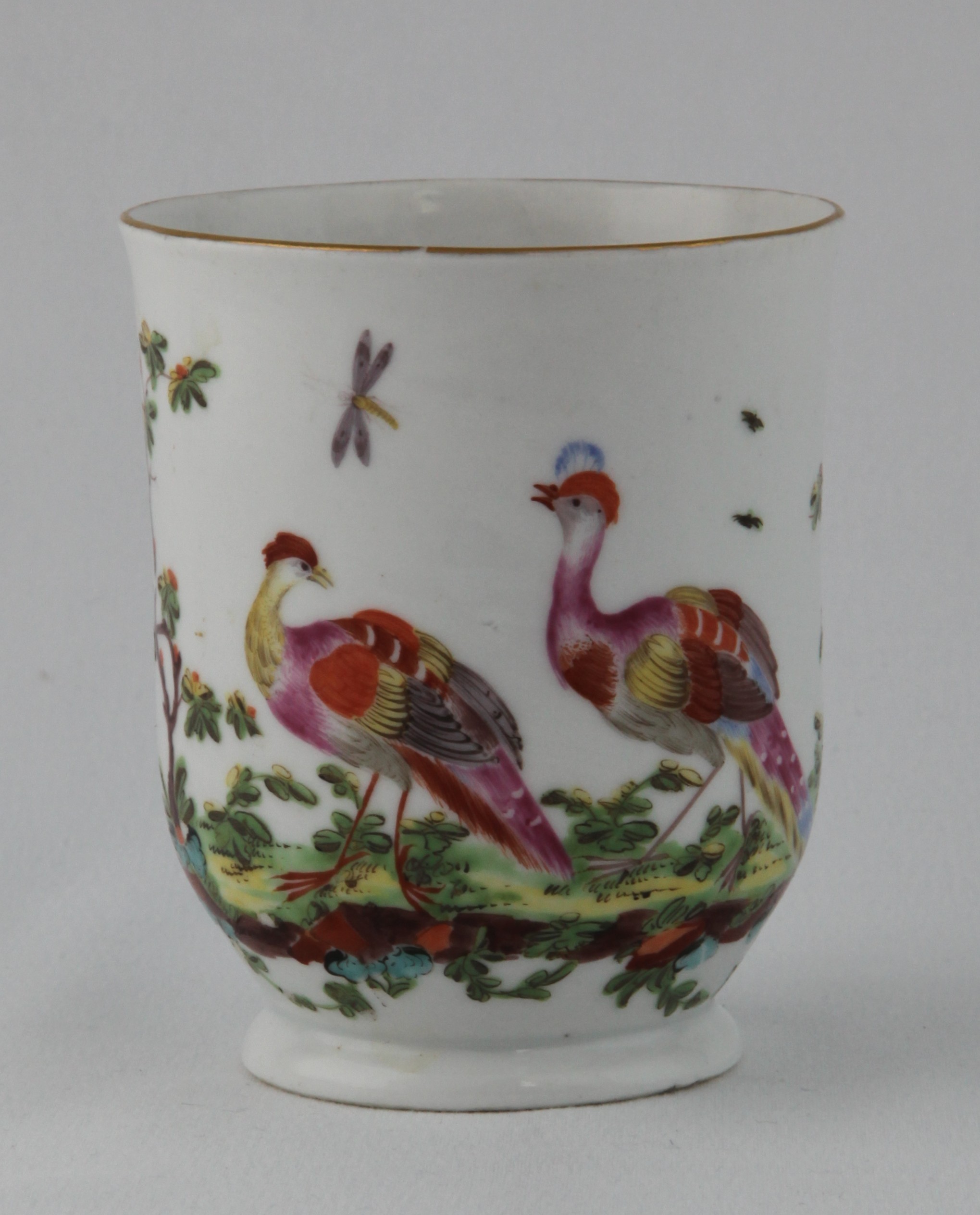 A Plymouth small 'U' shaped mug, with notched loop handle, painted in coloured enamels with two exotic birds in a wooded landscape, beneath a gilt line rim, 3 1/2" high, circa 1770, red painted tin mark