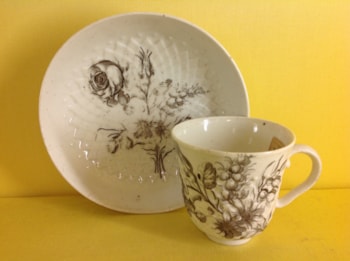 A rare Bristol coffee saucer,  pinecone moulded and finely printed in black with a flower spray, and the cup printed with a butterfly, circa 1775, no mark